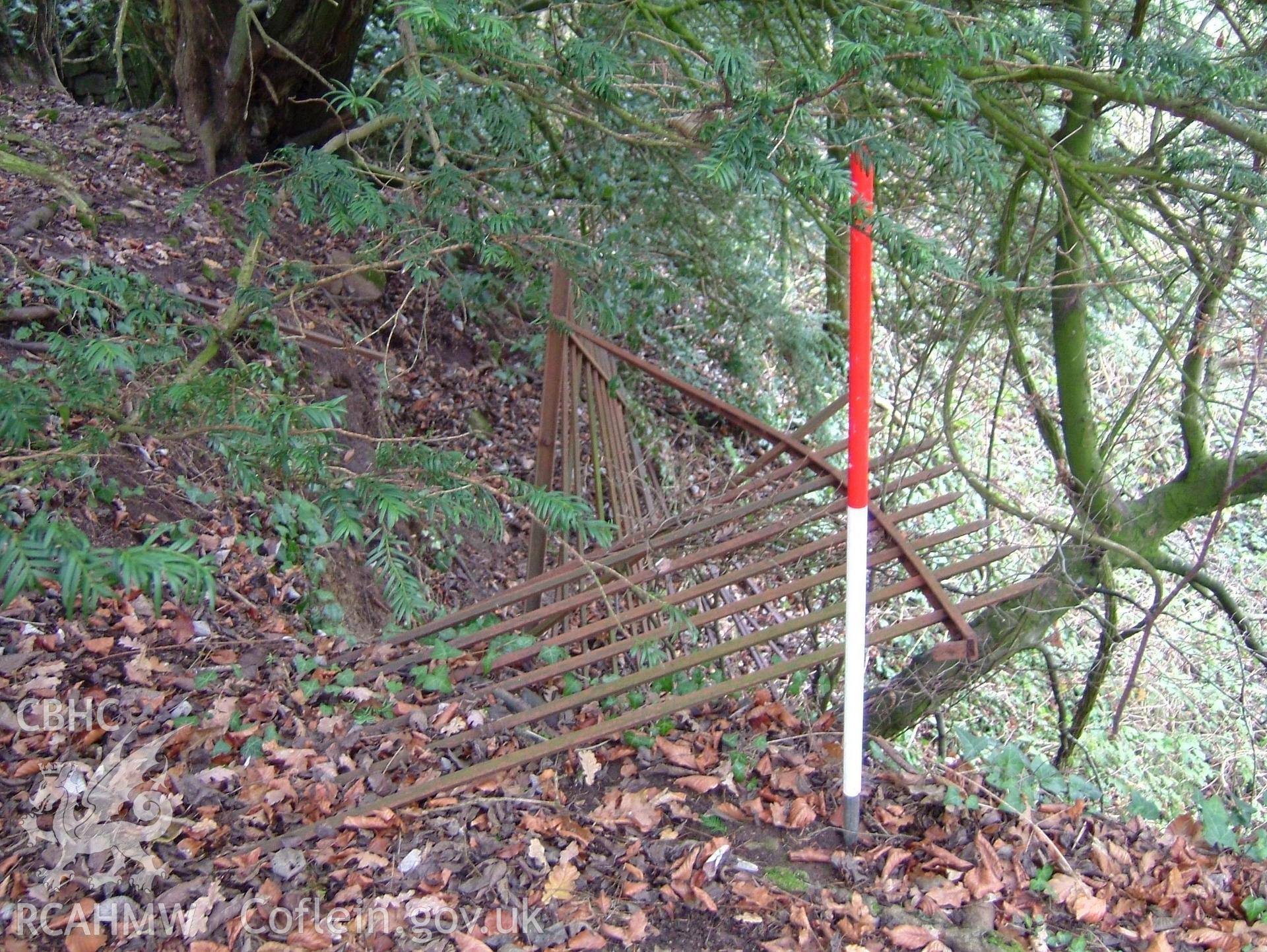 Digital colour photograph taken as part of an archaeological survey at the Piercefield walks, 2004. The photograph shows part of a disused fence at the Piercefield Estate.