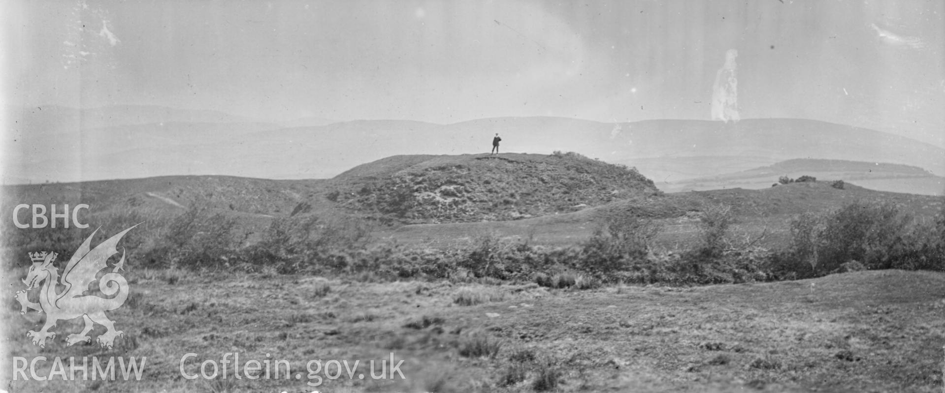 'Castell Gwallter 1910' landscape view with figure. Digitised from a photograph album showing views of Aberystwyth and District, produced by David John Saer, school teacher of Aberystwyth. Loaned for copying by Dr Alan Chamberlain.