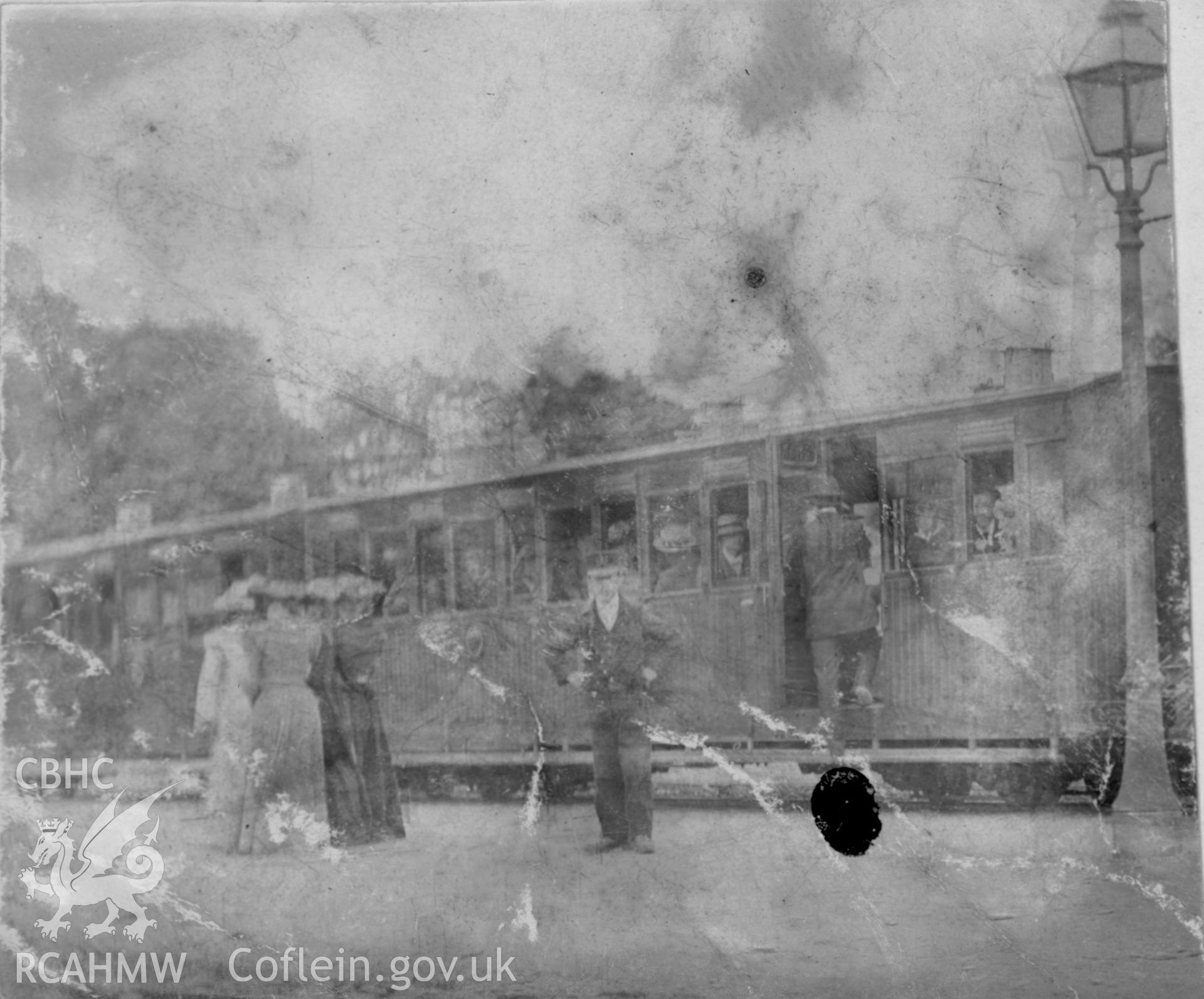 ''Devils Bridge Train 1909' view of train, guards and passengers.  Digitised from a photograph album showing views of Aberystwyth and District, produced by David John Saer, school teacher of Aberystwyth. Loaned for copying by Dr Alan Chamberlain.