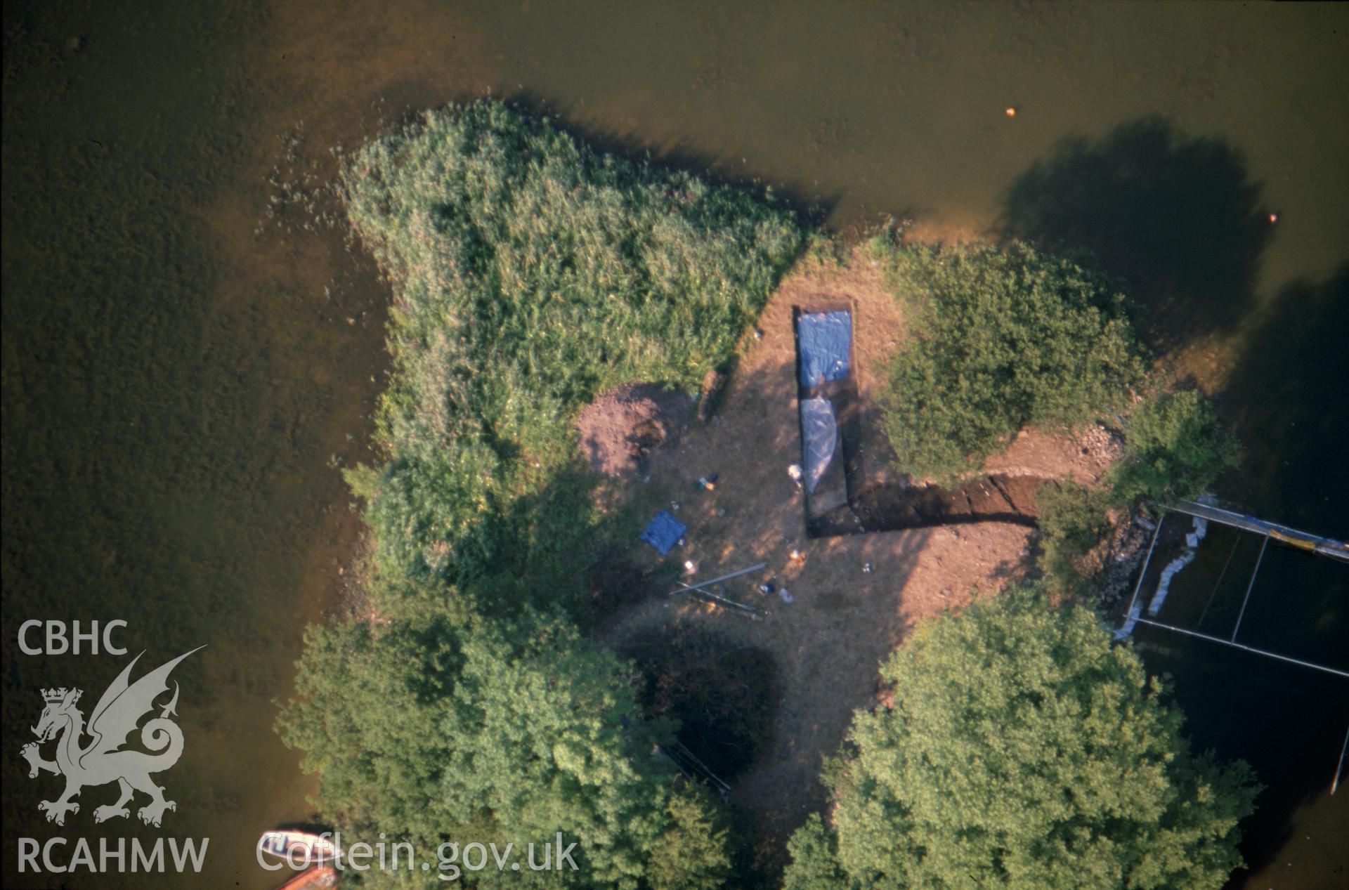 Slide of RCAHMW colour oblique aerial photograph of Llangorse Crannog, taken by C.R. Musson, 1989.