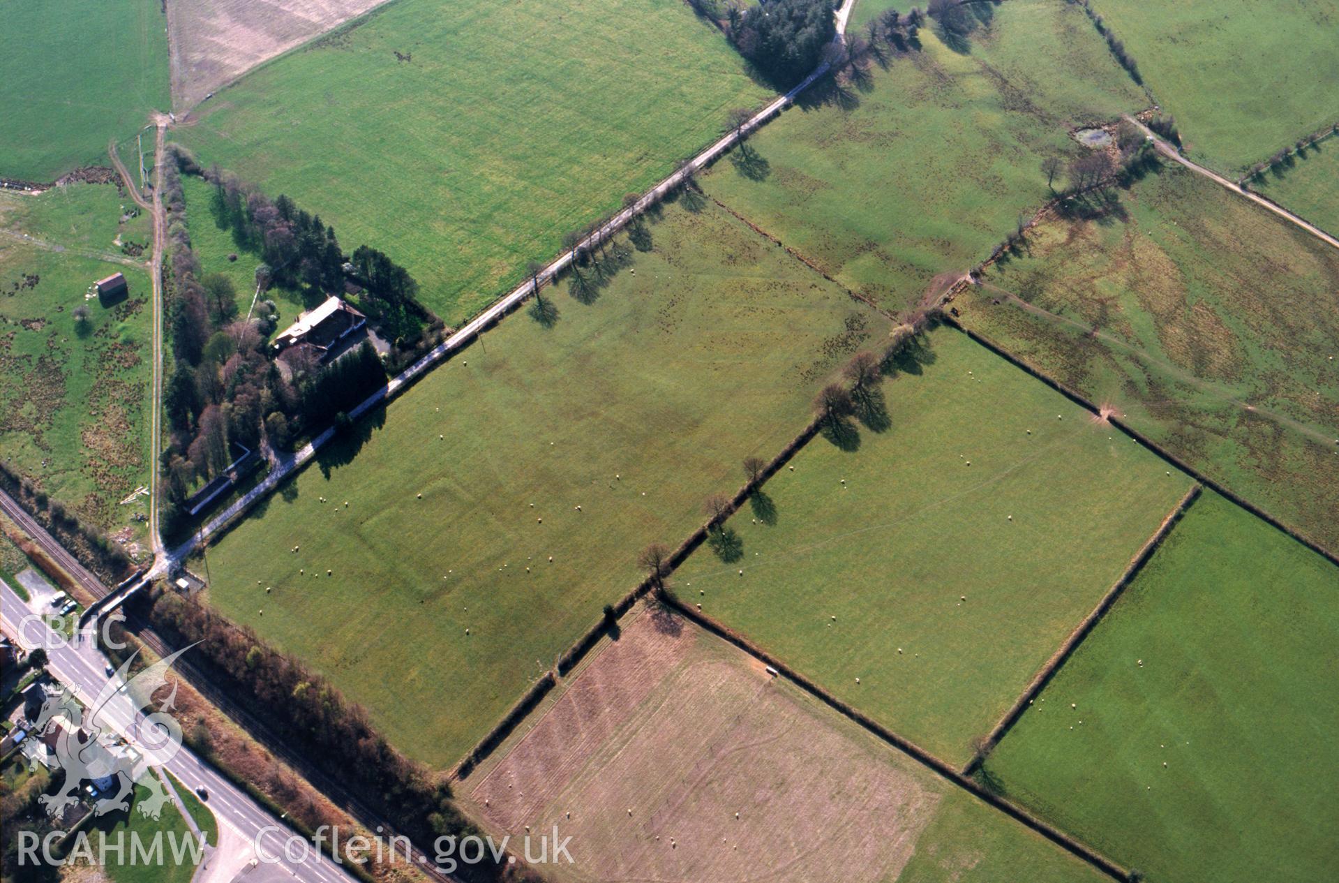 Slide of RCAHMW colour oblique aerial photograph of Roman Earthworks S Of Llandrindod Wells, taken by C.R. Musson, 12/4/1995.