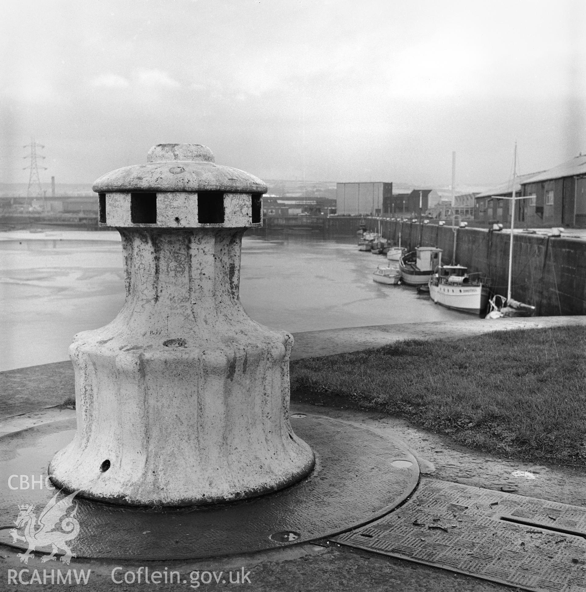 Black and white photograph showing capstan on the quayside near the North Dock entrance gate.