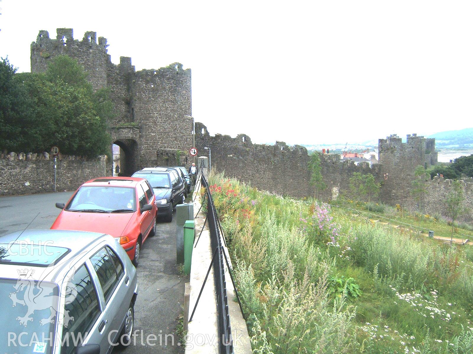 Outer elevation of gate and wall to next tower to the south-east from the south-west.