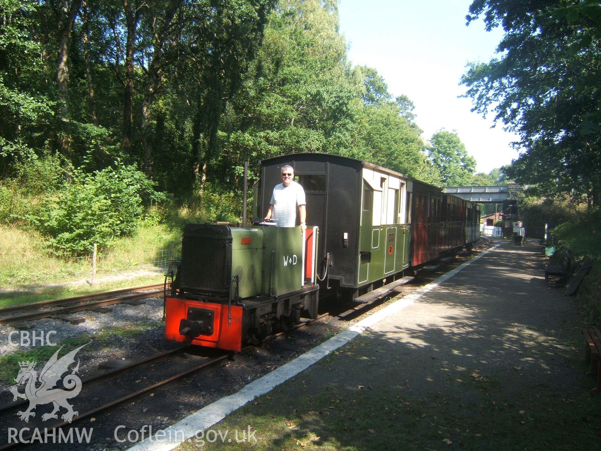 Tractor at head of train of replica coaches from SW.