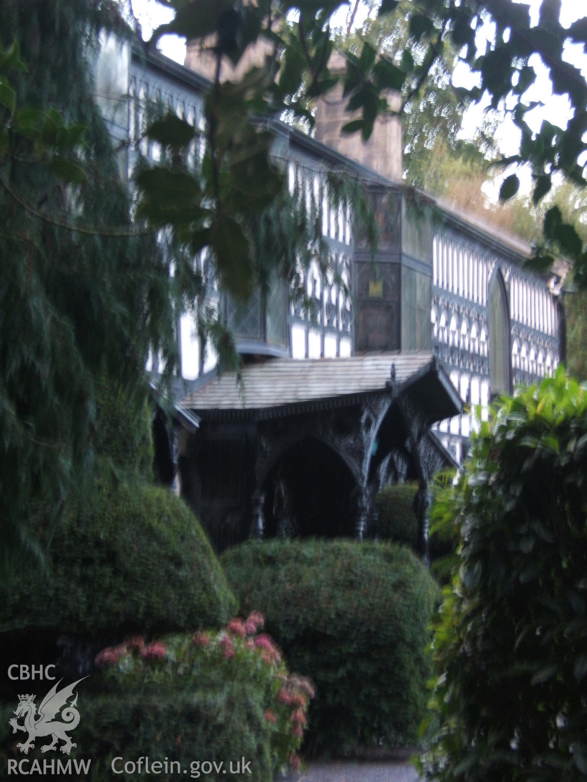 Ornate W timber entrance from west.