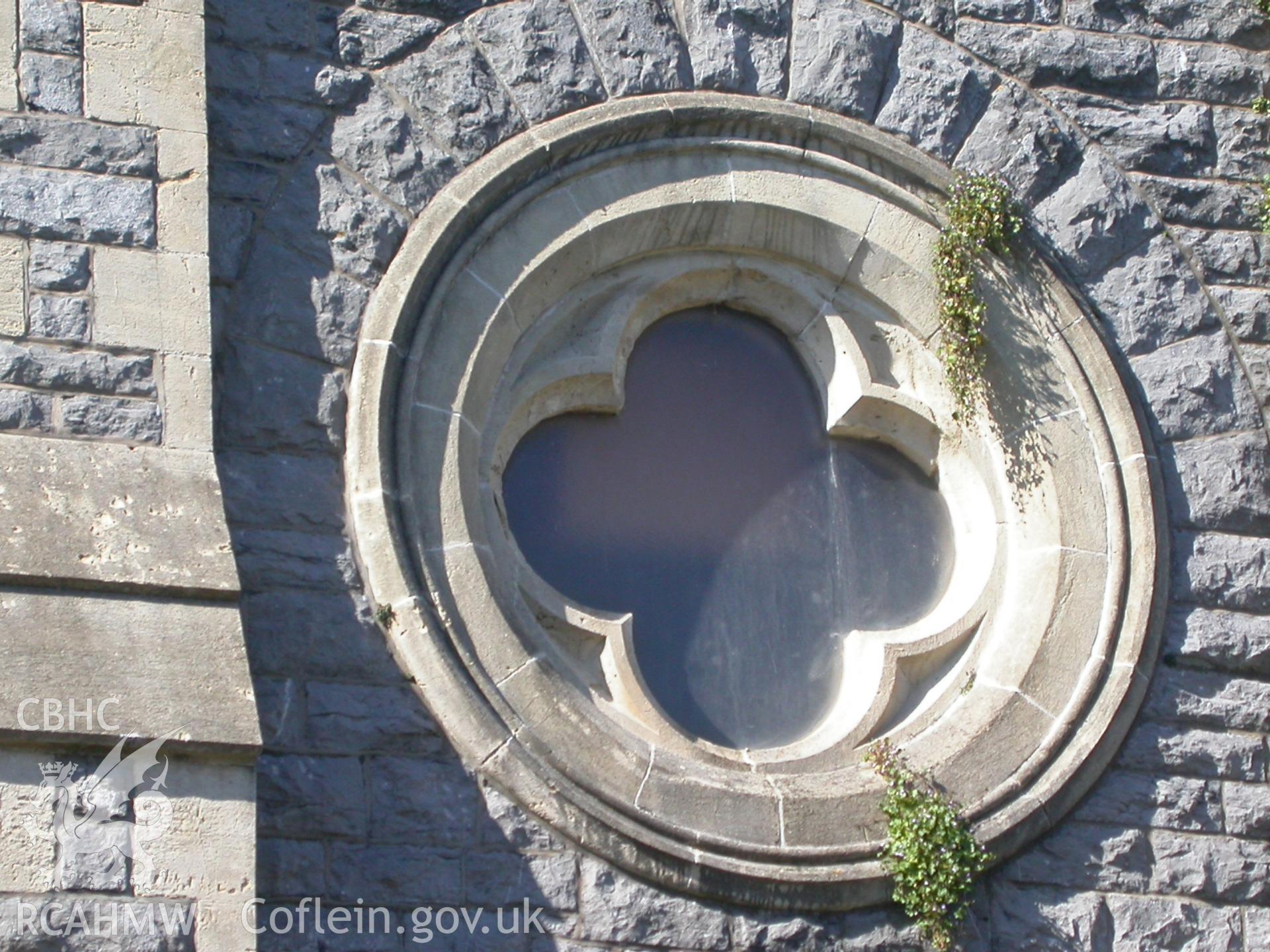 Quadrefoil circular windows in outer bays of south-west front.