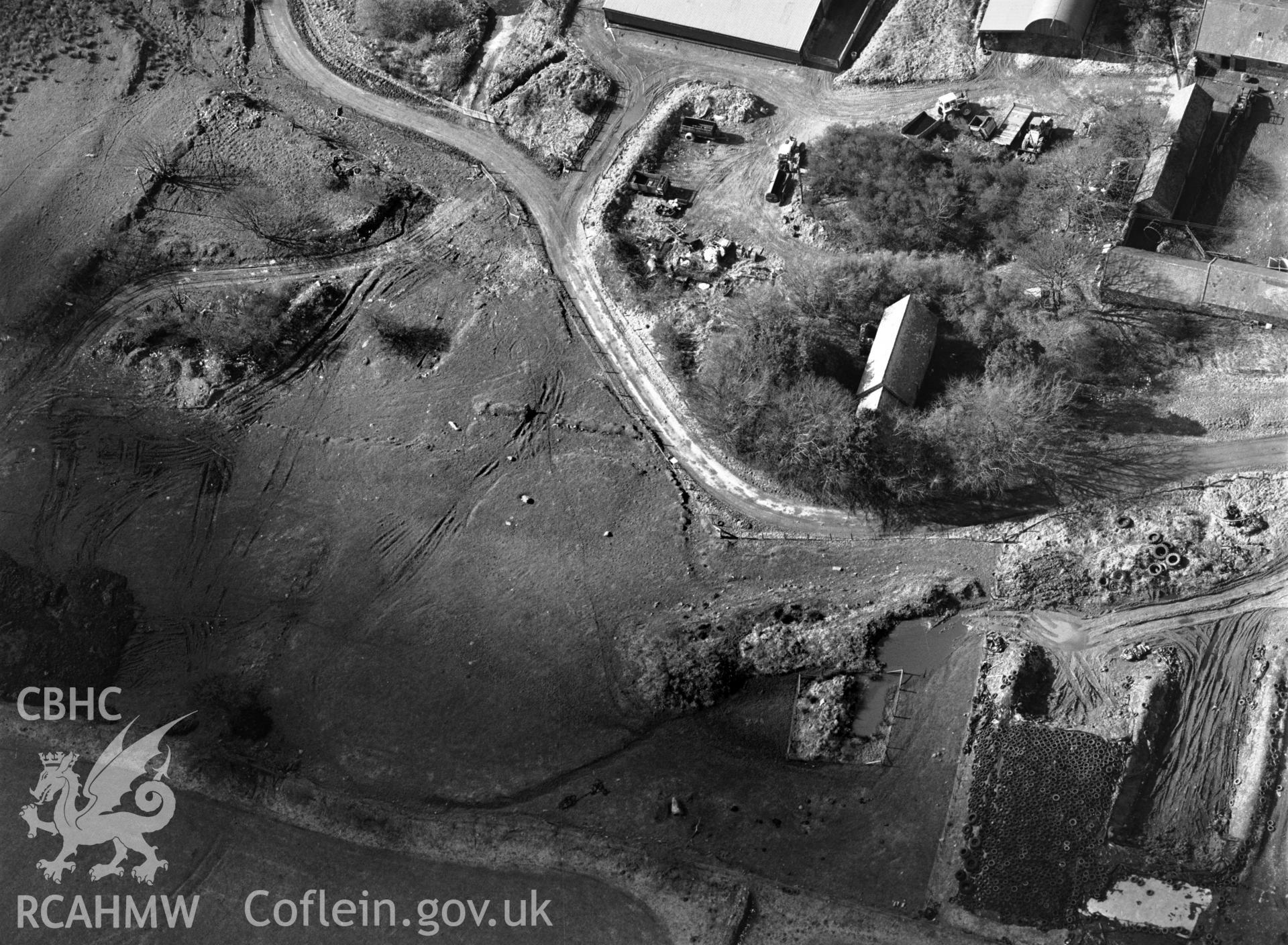 RCAHMW black and white oblique aerial photograph of St John The Baptist's Church, Morvil, taken by C R Musson, 27/02/1996.