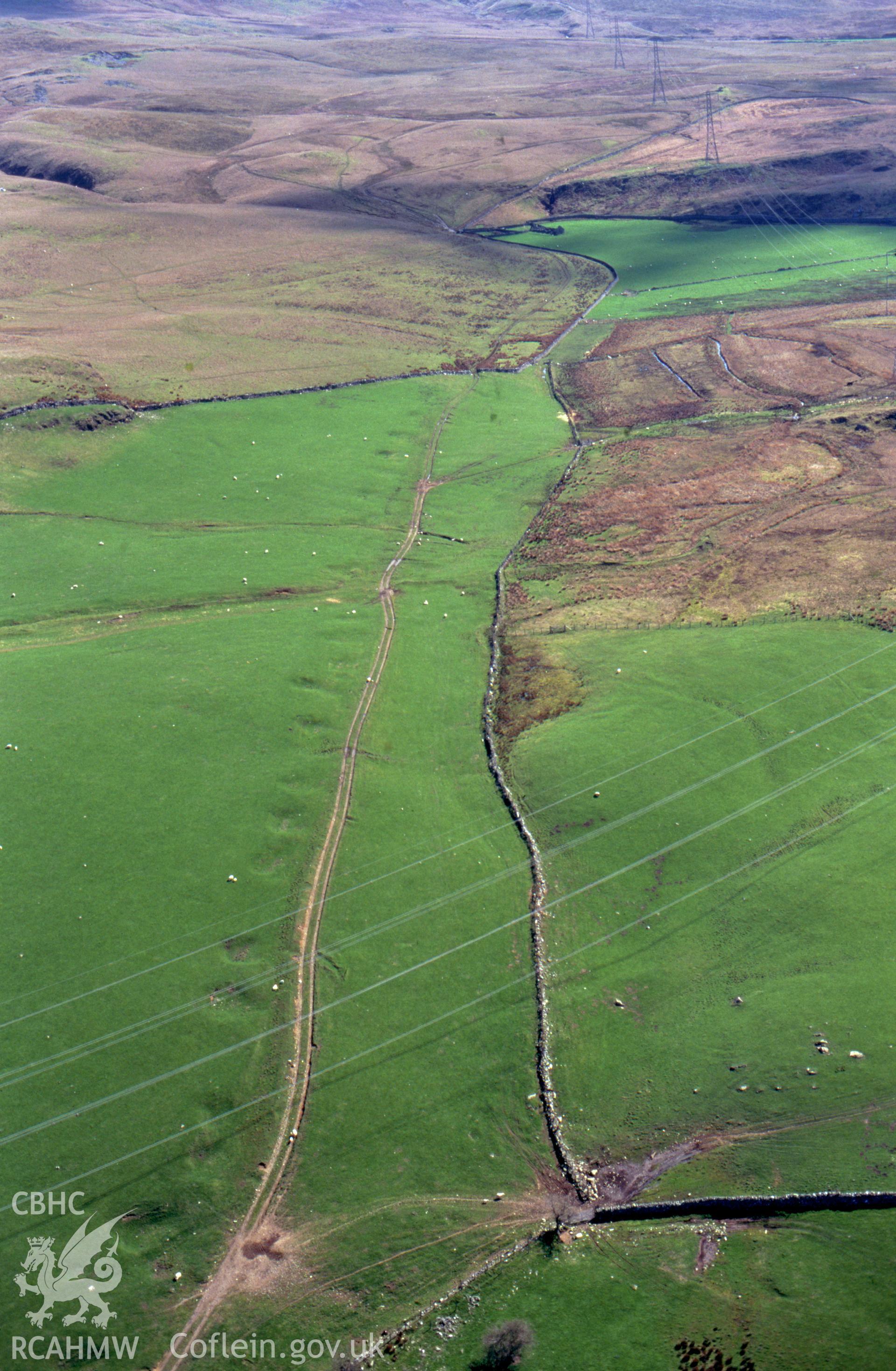 RCAHMW colour slide oblique aerial photograph of probable Roman road W of Dolbelydr, Trawsfynydd, taken by C.R.Musson on the 30/03/1996