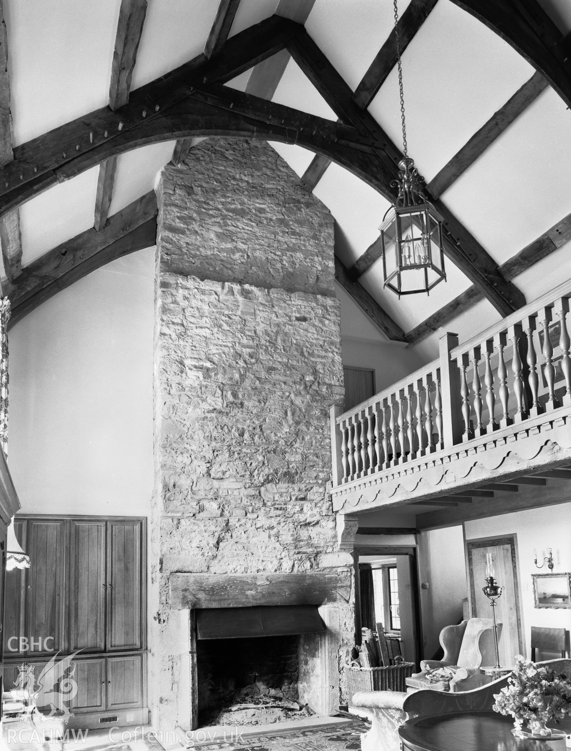 Interior view showing fireplace and chimney in galleried room.