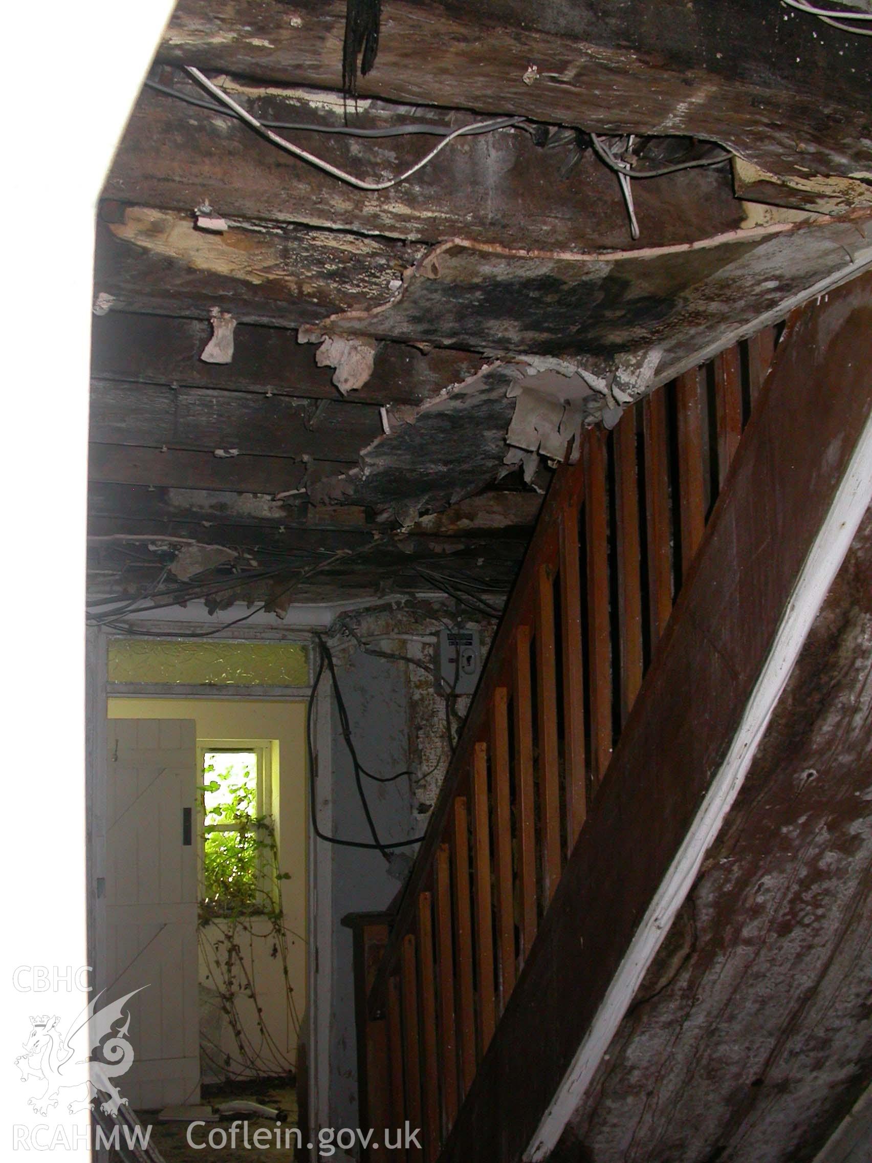 Former inner-room with modern stairs and doorway to bathroom at rear.