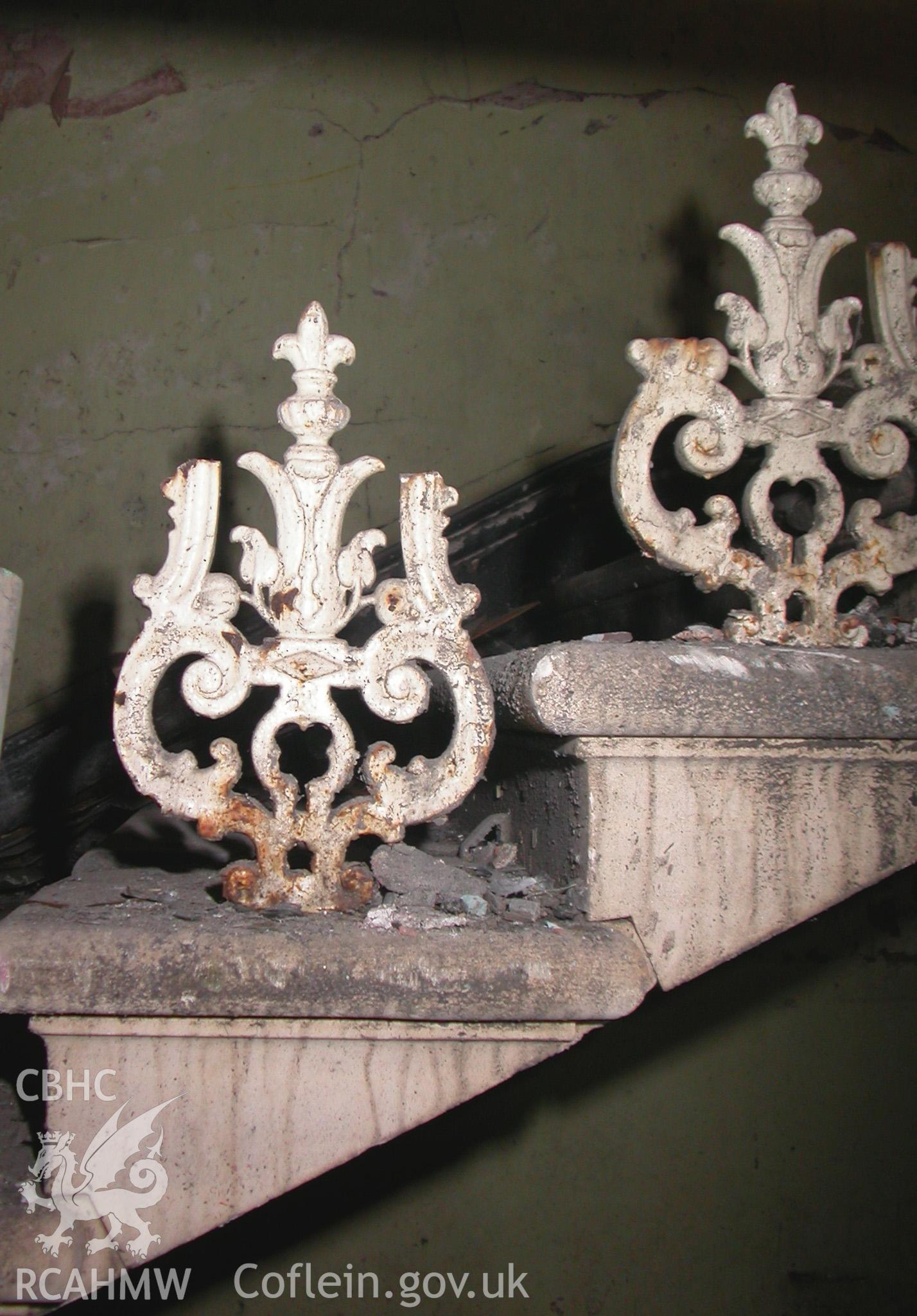 Main hall, detail shot of the remnants of the base of the cast iron balusters on the hall staircase.