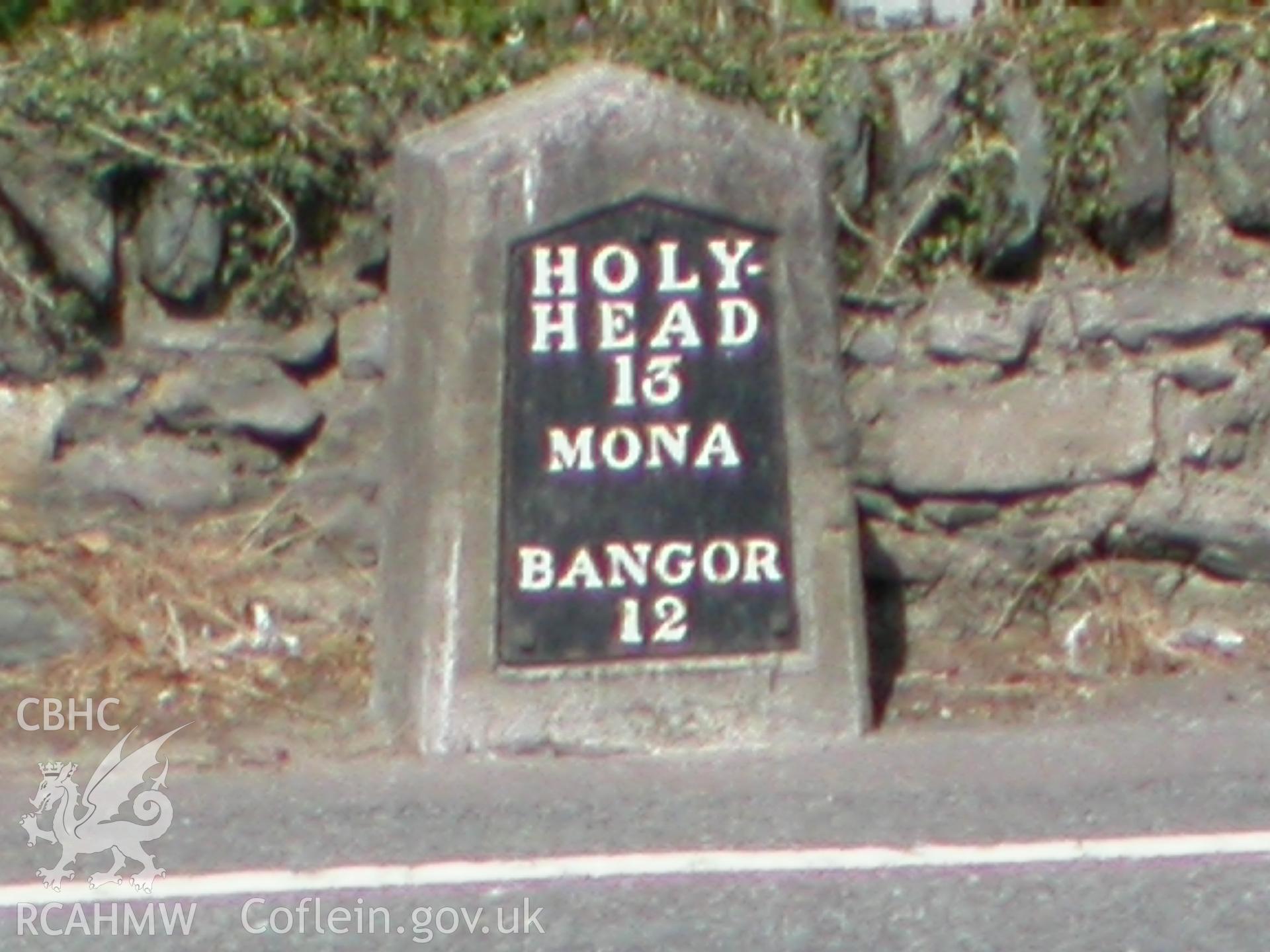 Milestone in road opposite with cast-iron inscription.