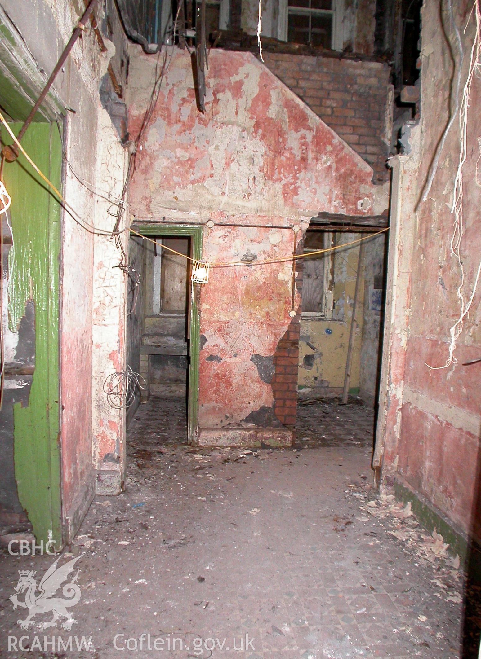 Ground floor, lobby to rear of hall, connecting reception rooms to service areas, looking east.