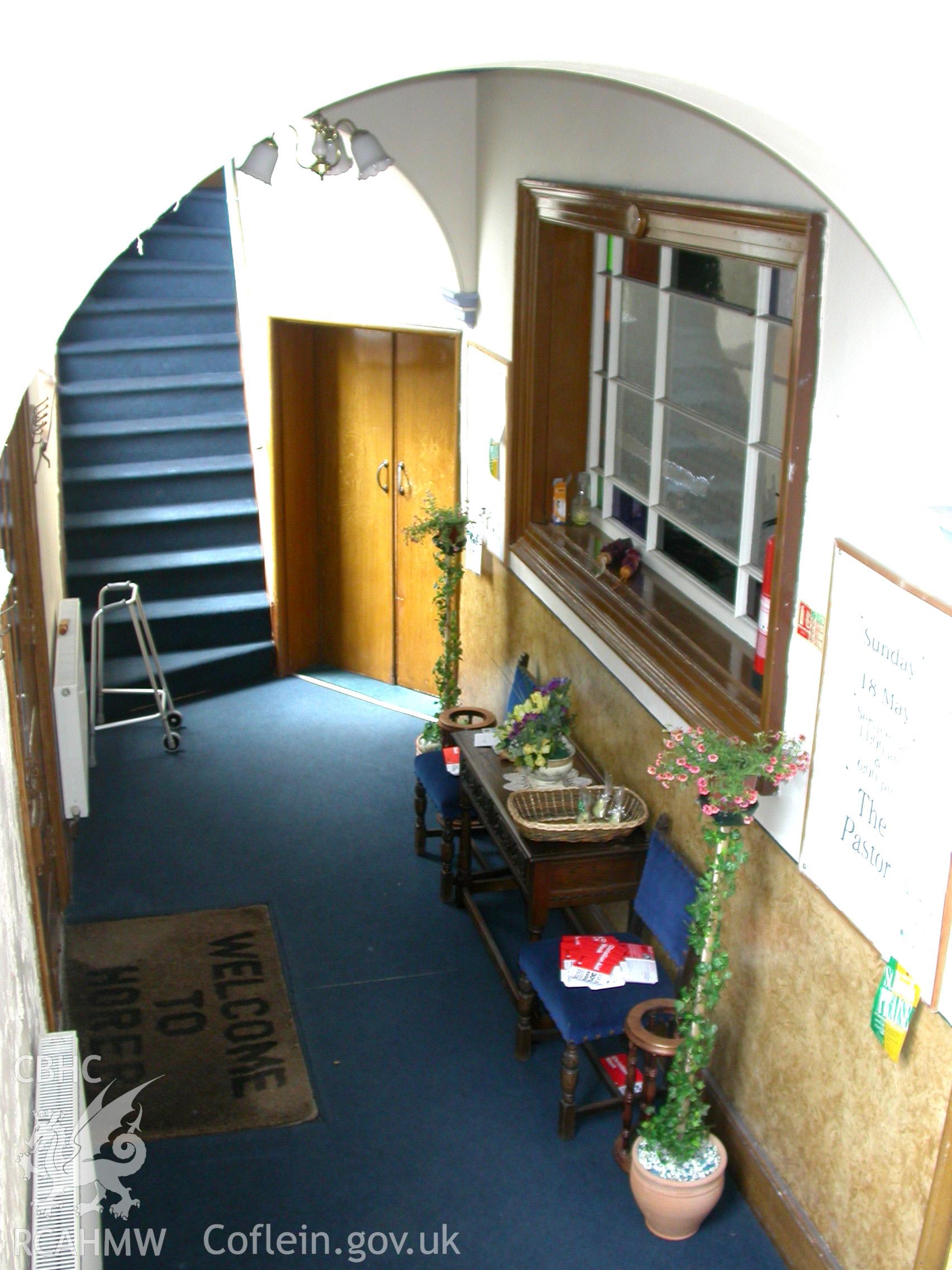 Lobby, showing SW gallery stairs, entrance door to NW aisle & window into chapel.