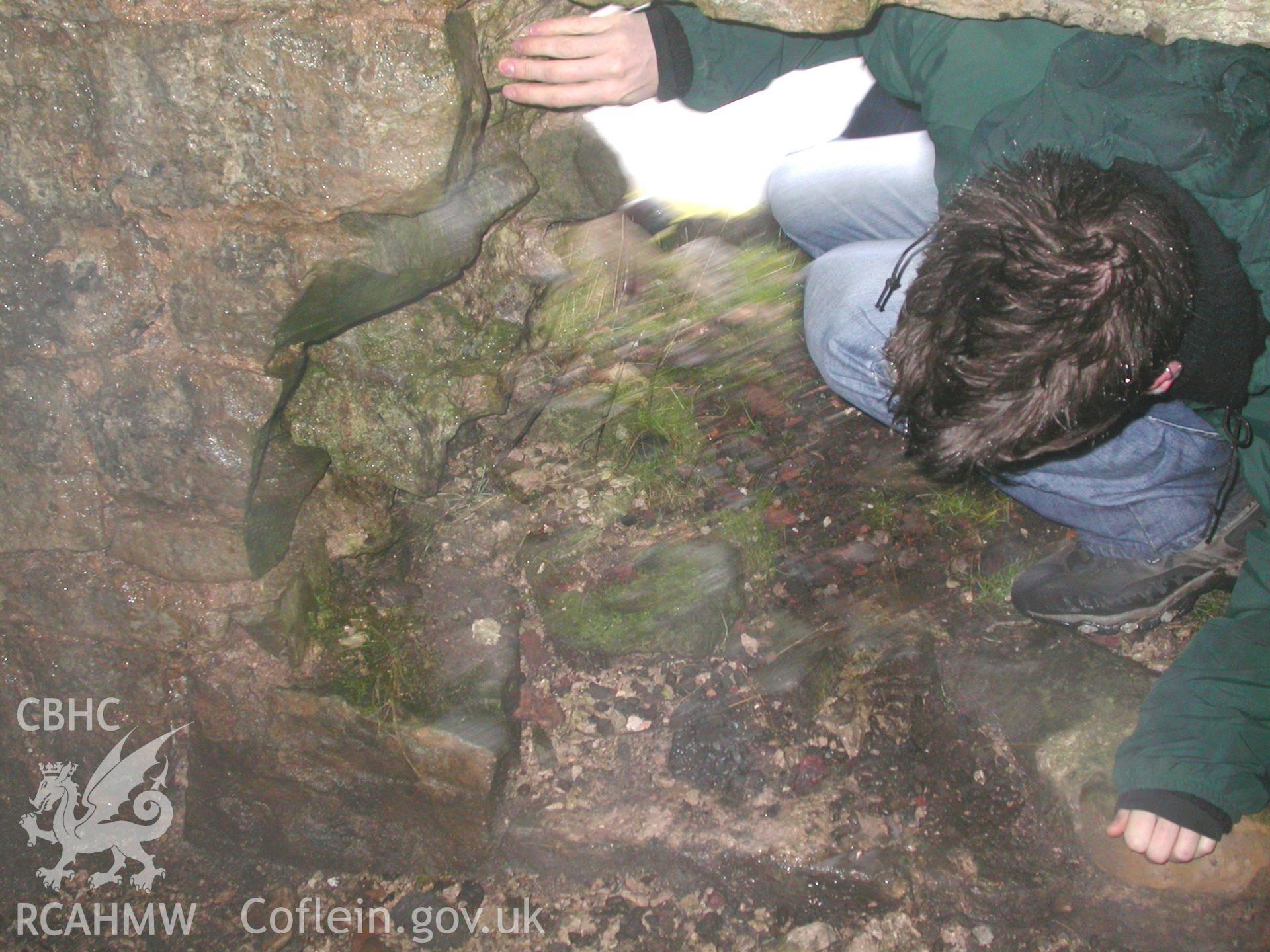 Bristol University student entering hole in NW wall of tunnel.