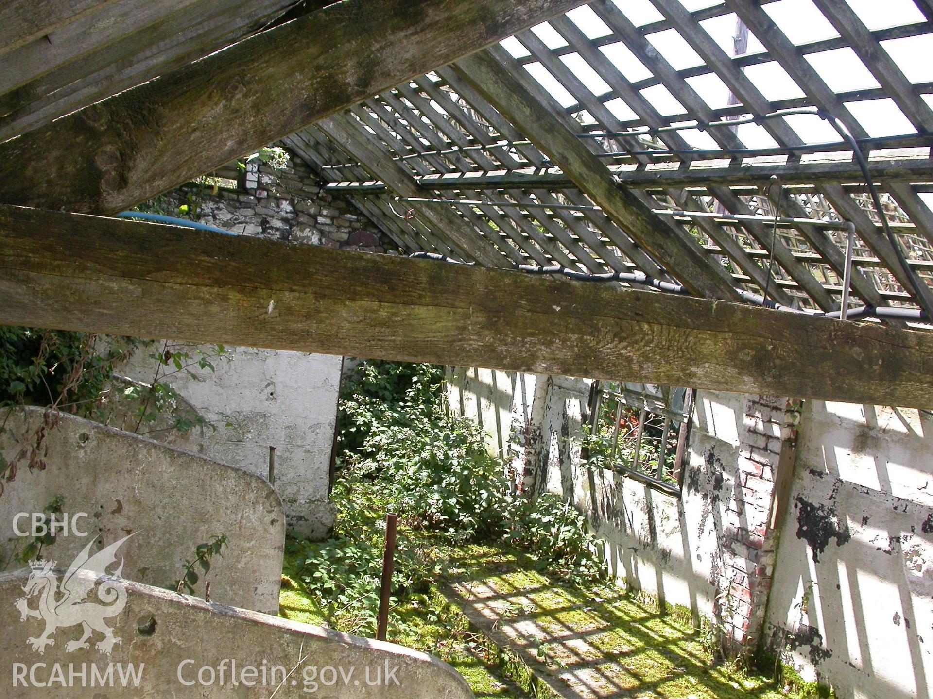 Late C19th cow-house, interior roof-trusses and lateral tethering.