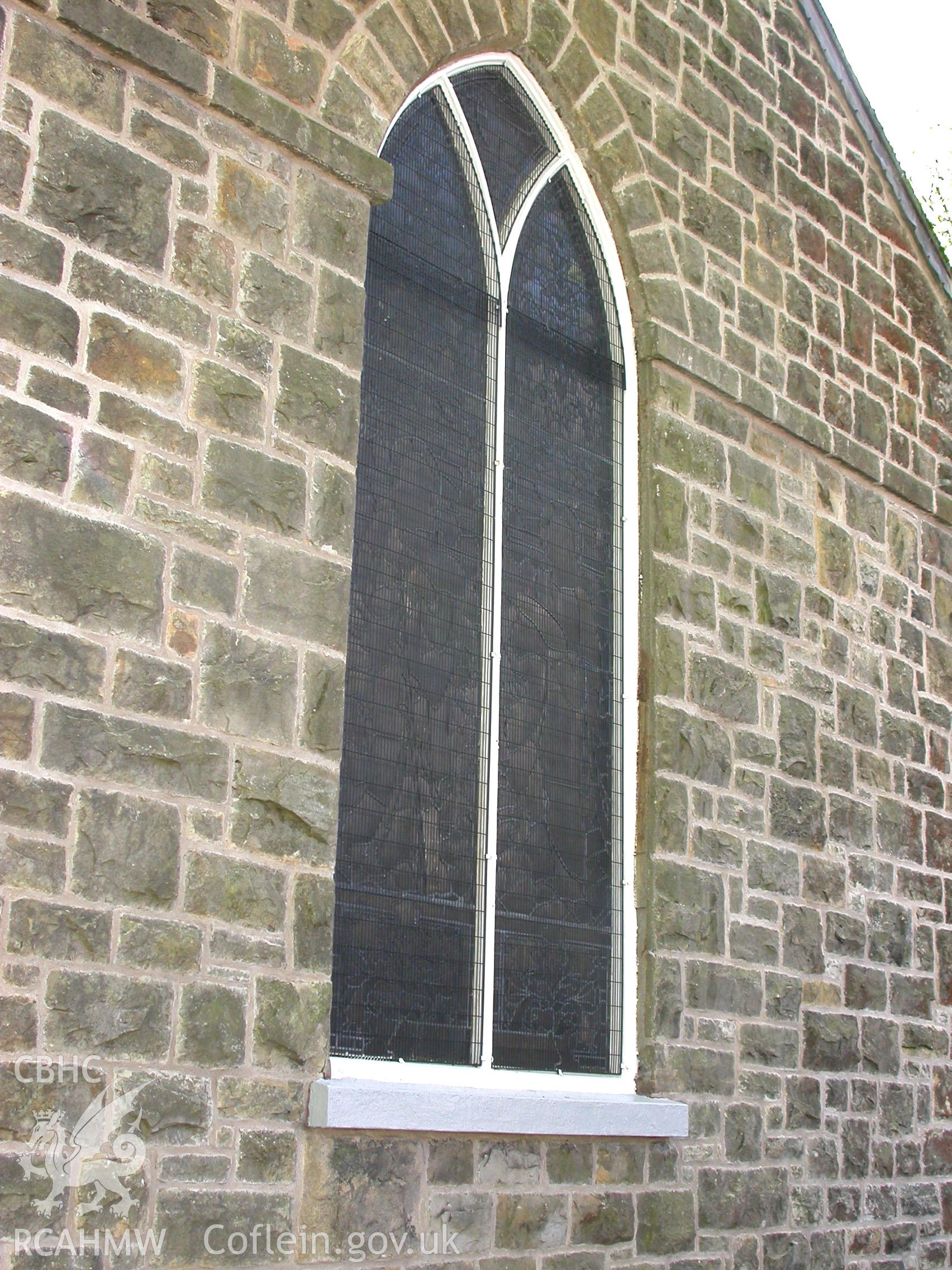 Replicated cast-iron tracery replacing wooden tracery on later chancel east window.