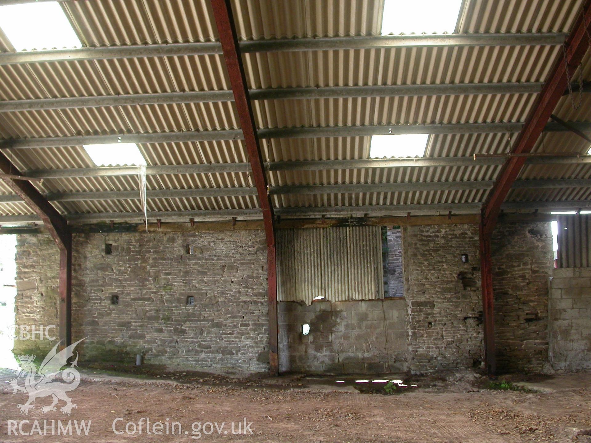 C19th barn, north elevation and late C20th, 4-bay iron girder/corrugated-roof building.