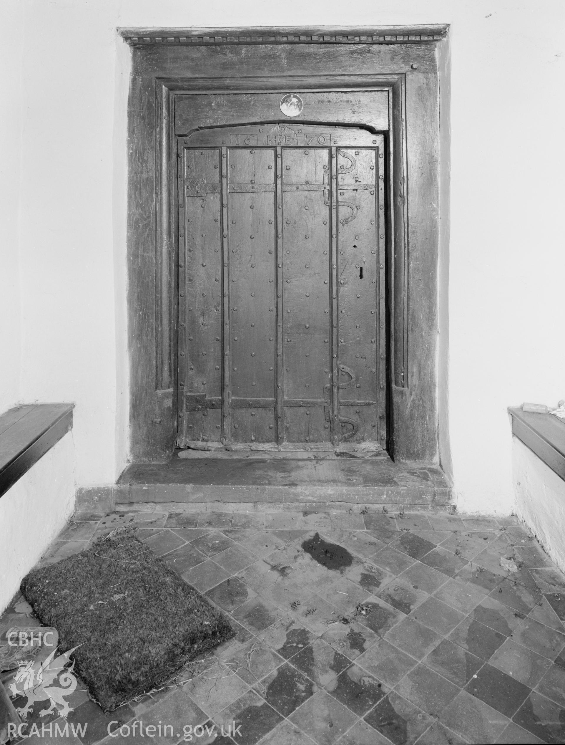 Interior view of farmhouse, showing oak door