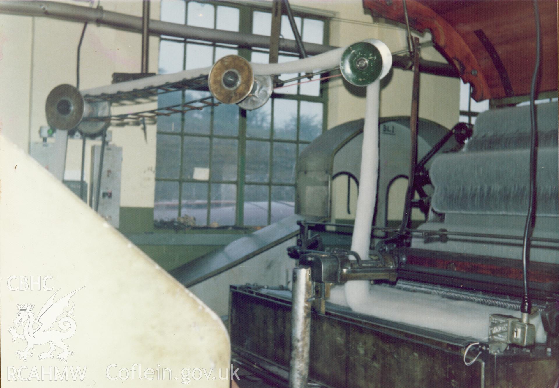 Interior view showing the belt joining the scribbler and the carder at Cambrian Wool Factory.