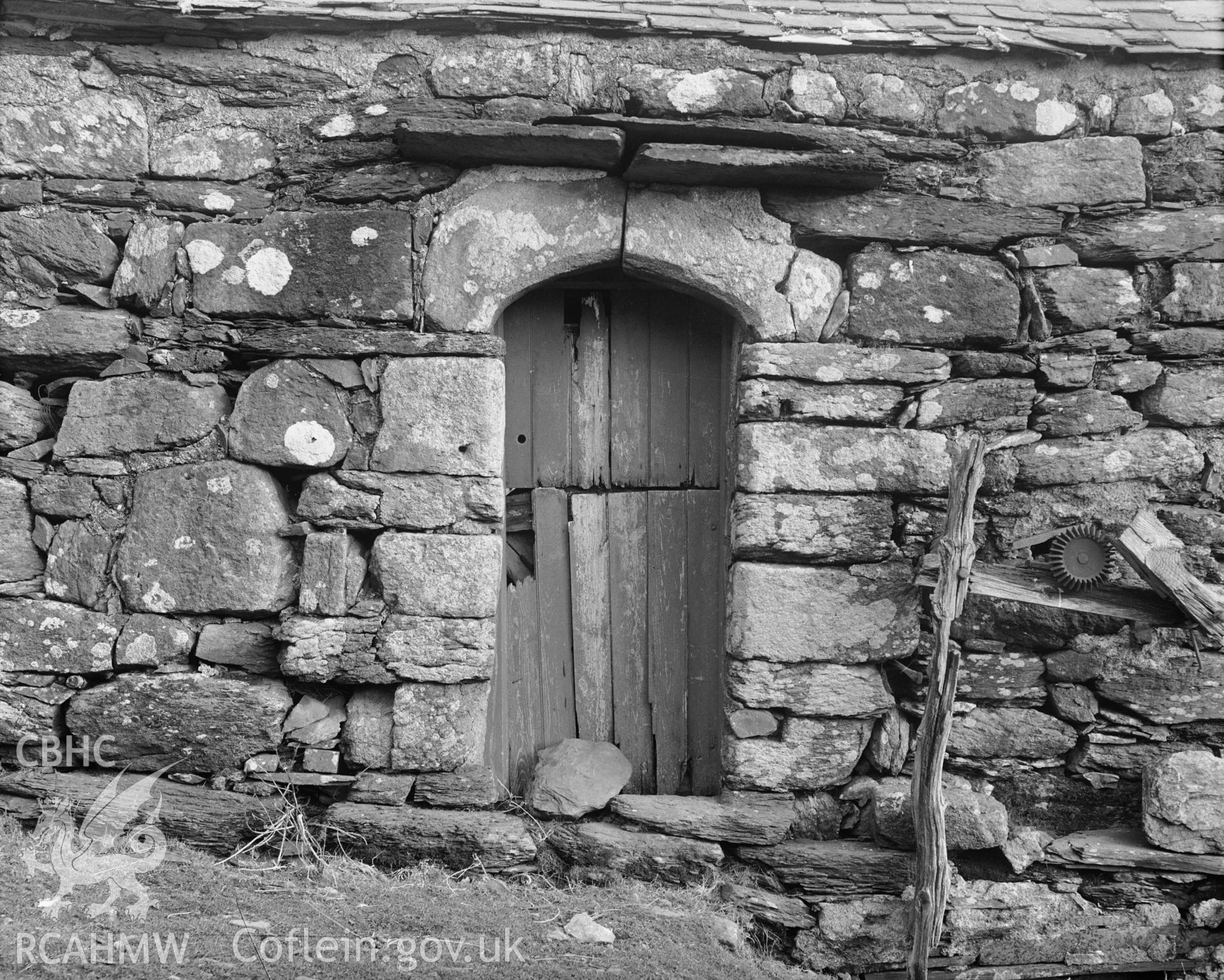 Black and white photograph showing the doorway in the west wall of the barn.