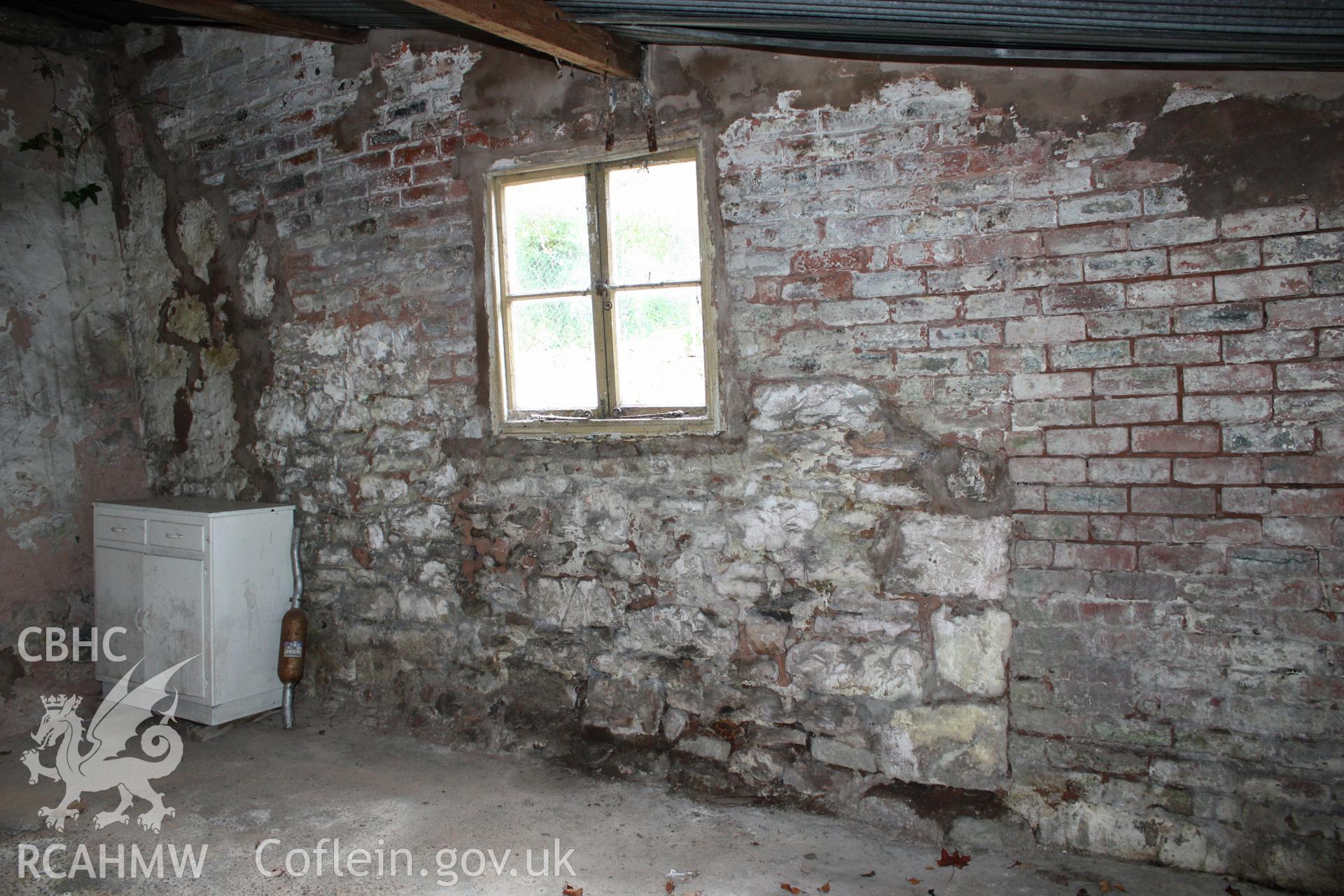 Interior of lean to garages, in rear projecting wing, showing south end wall.