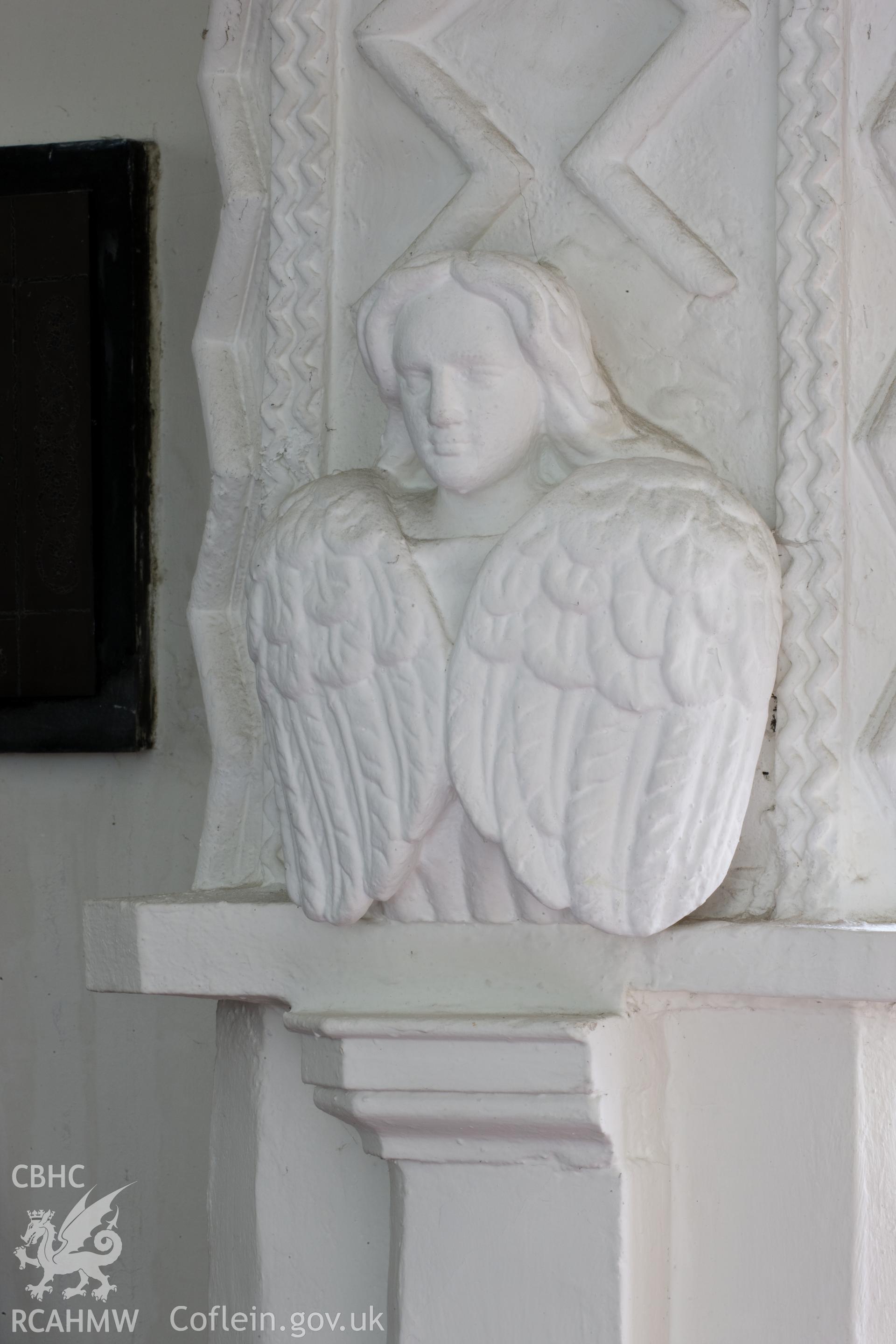 Plaster figure on south base of chancel arch.