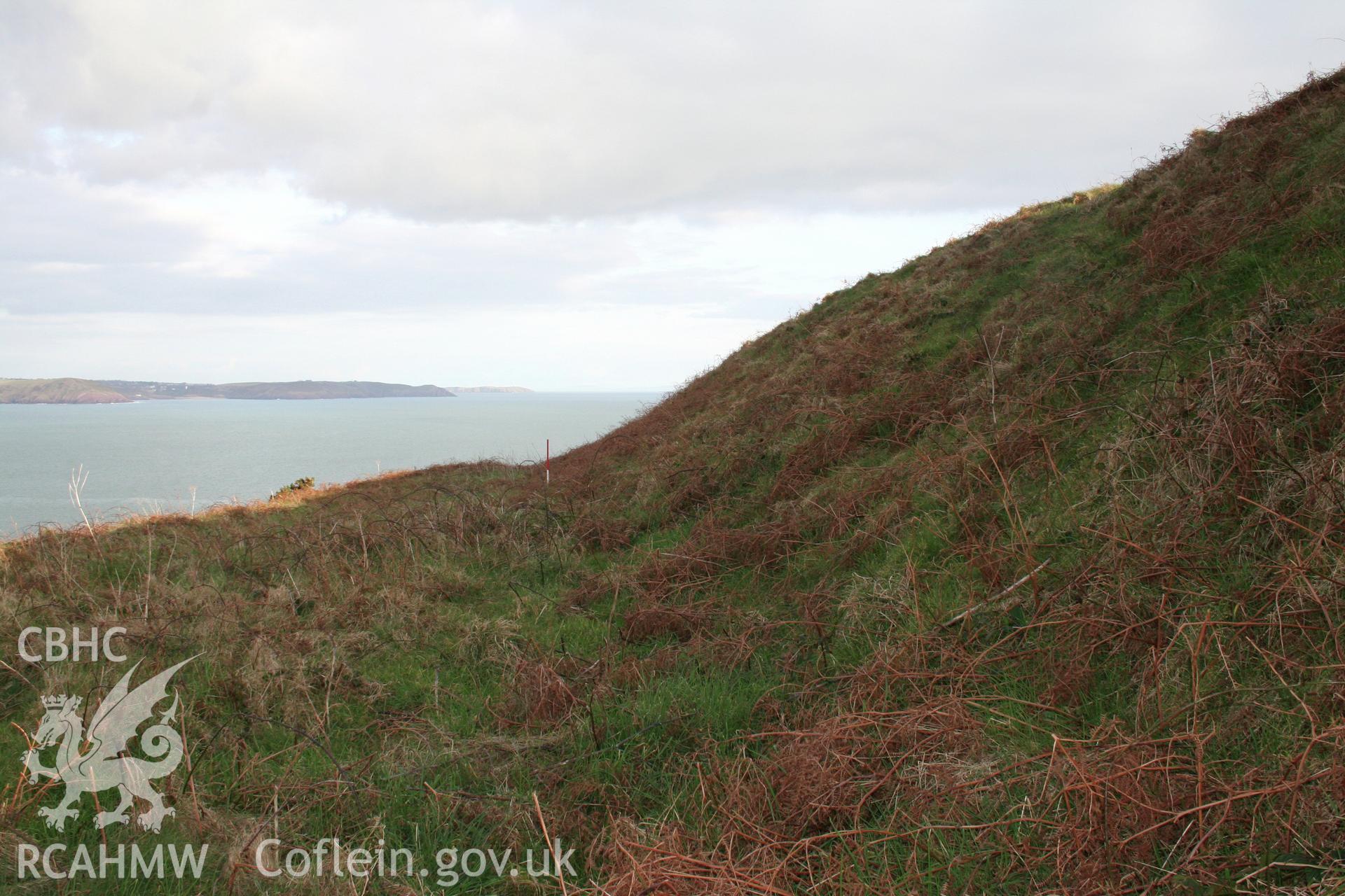 Looking east alongthe terrace at the base of the inner rampart scarp slope to the north of the forts interior.