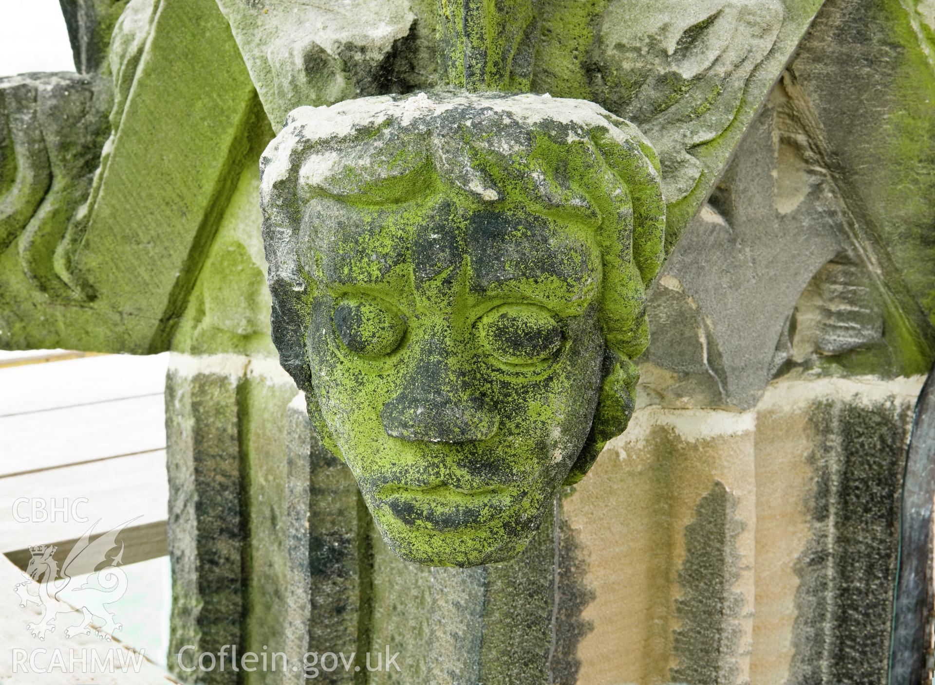 Carved heads on bases of finials, four to a base, moving clock-wise.