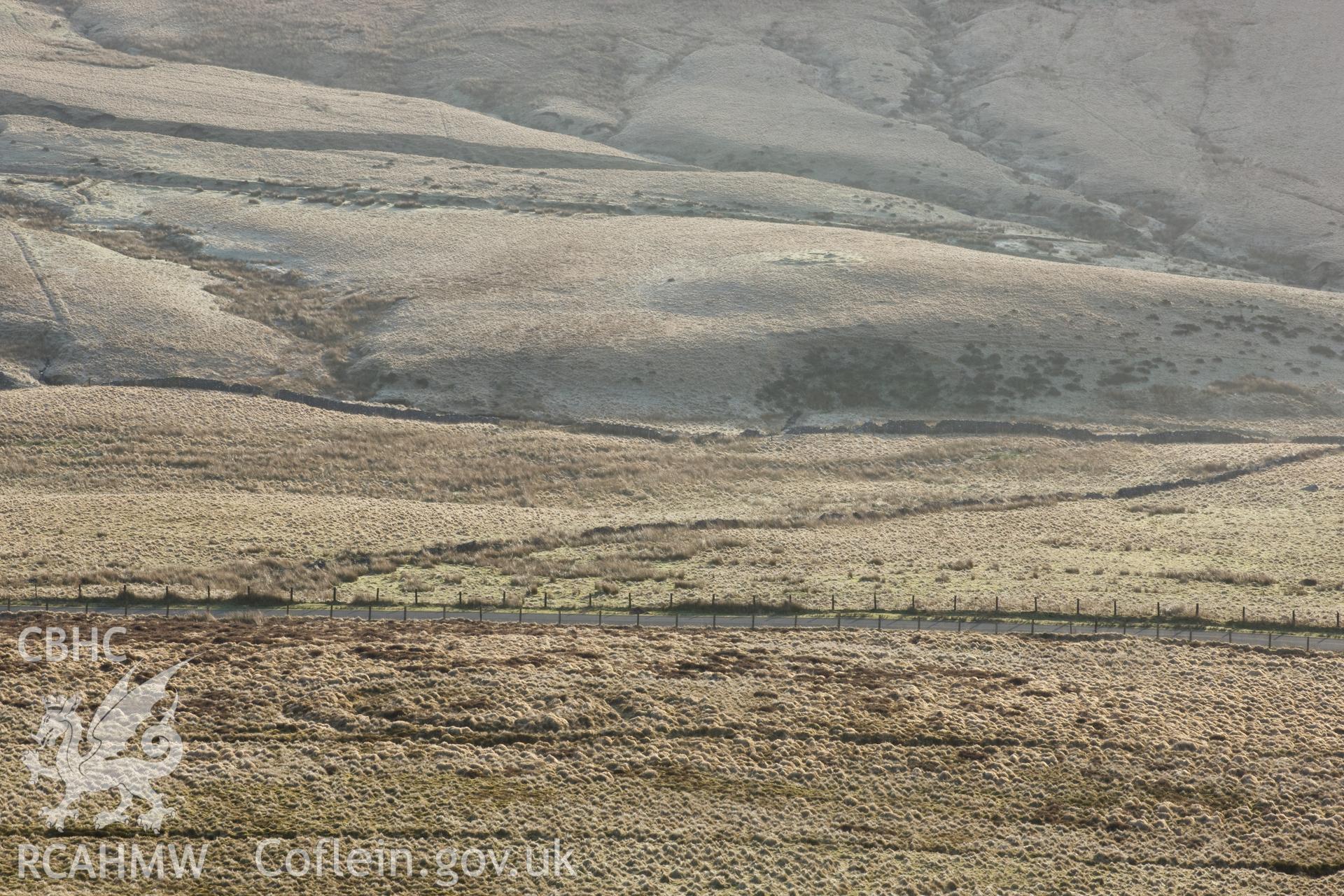 Distant view from the west, dawn, cairn in background.