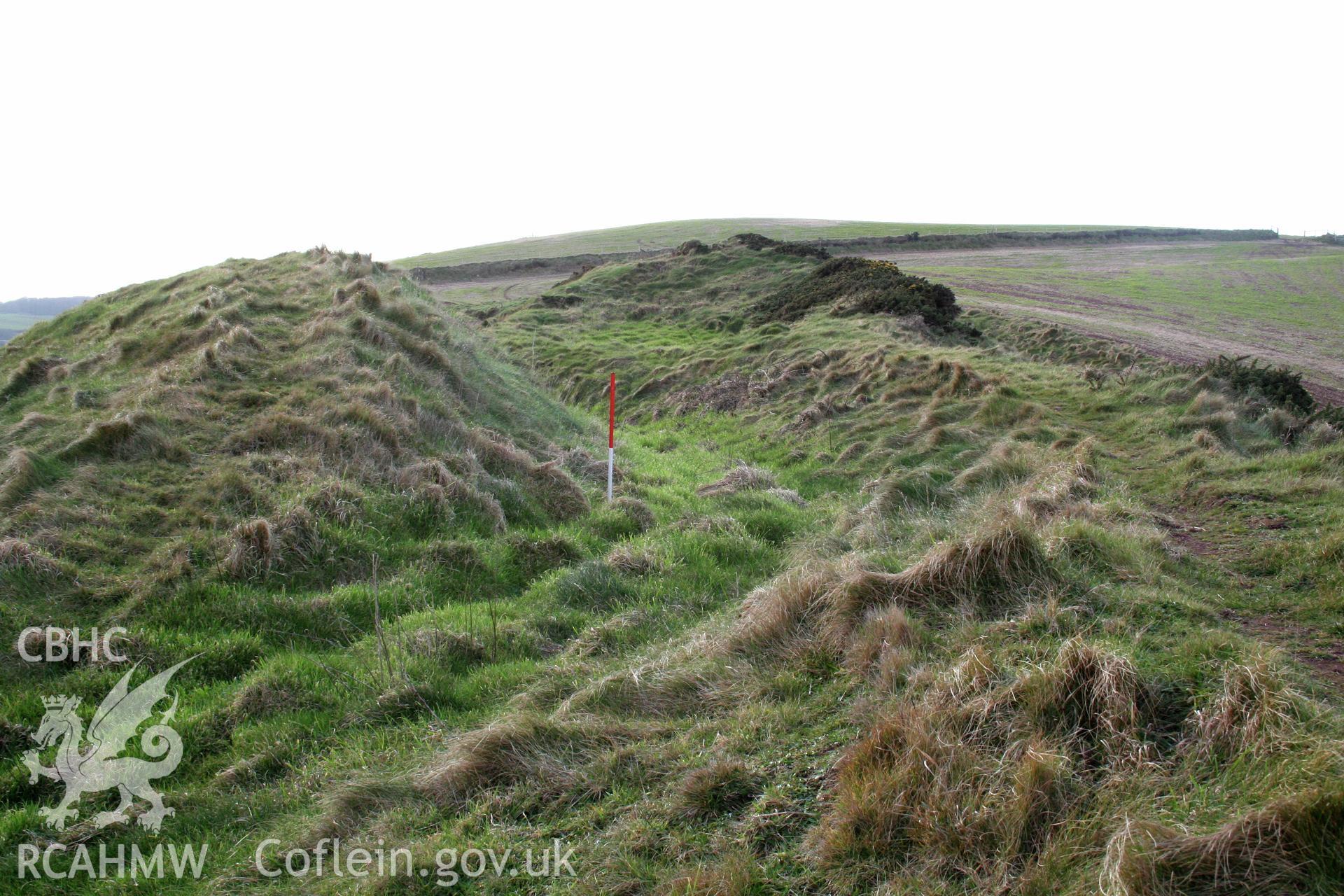 Looking west across the middle rampart bank, ditch and outer rampart bank of the annexe defences.