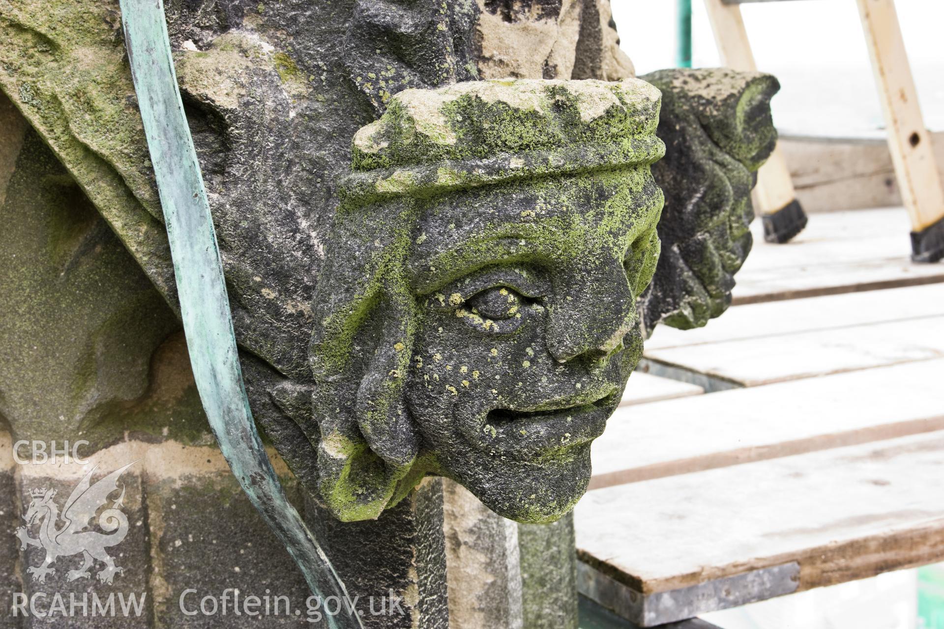 Carved heads on bases of finials, four to a base, moving clock-wise.