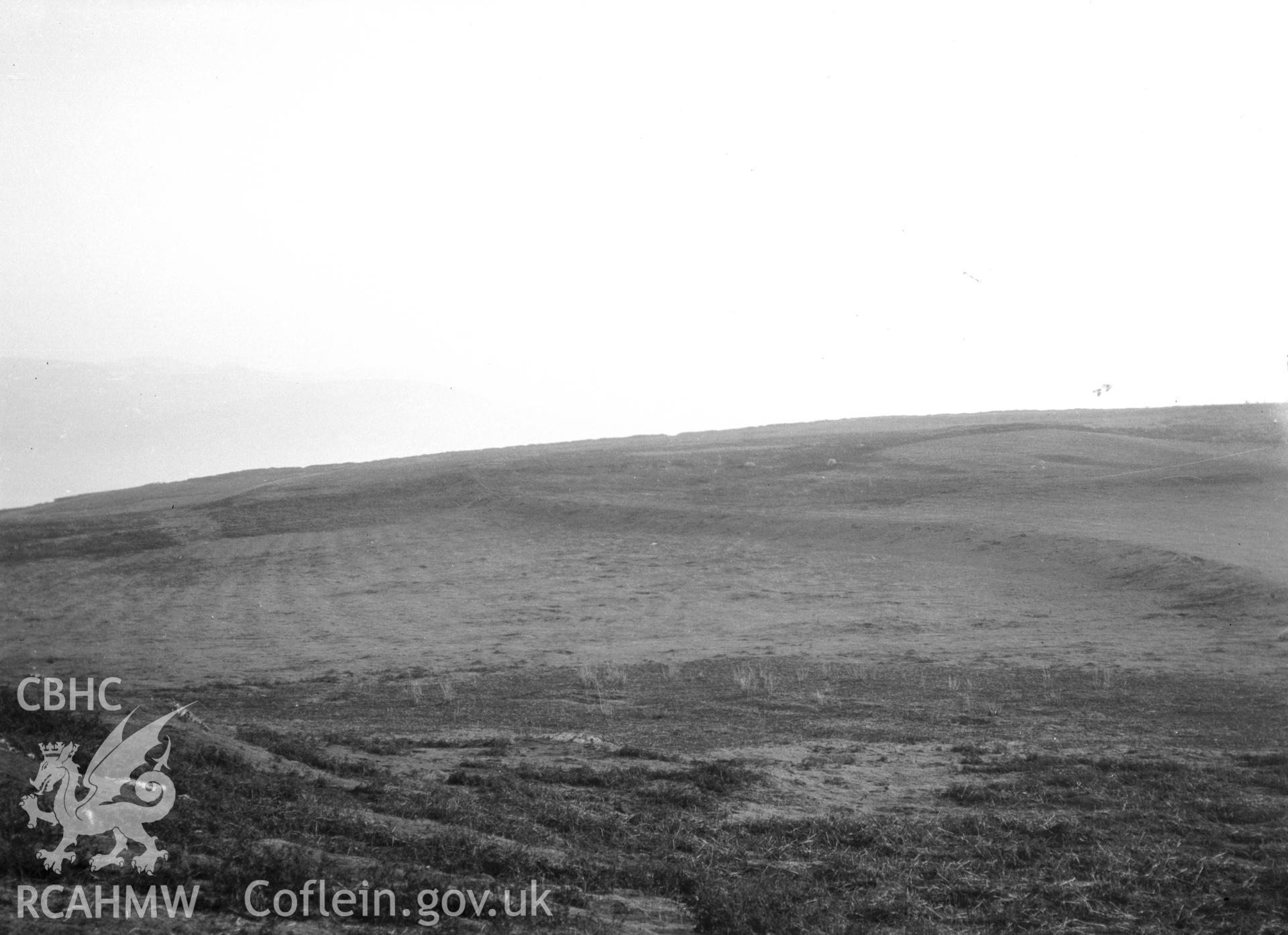 General view of Penmon Park, showing lynchets near the cross in the evening light.