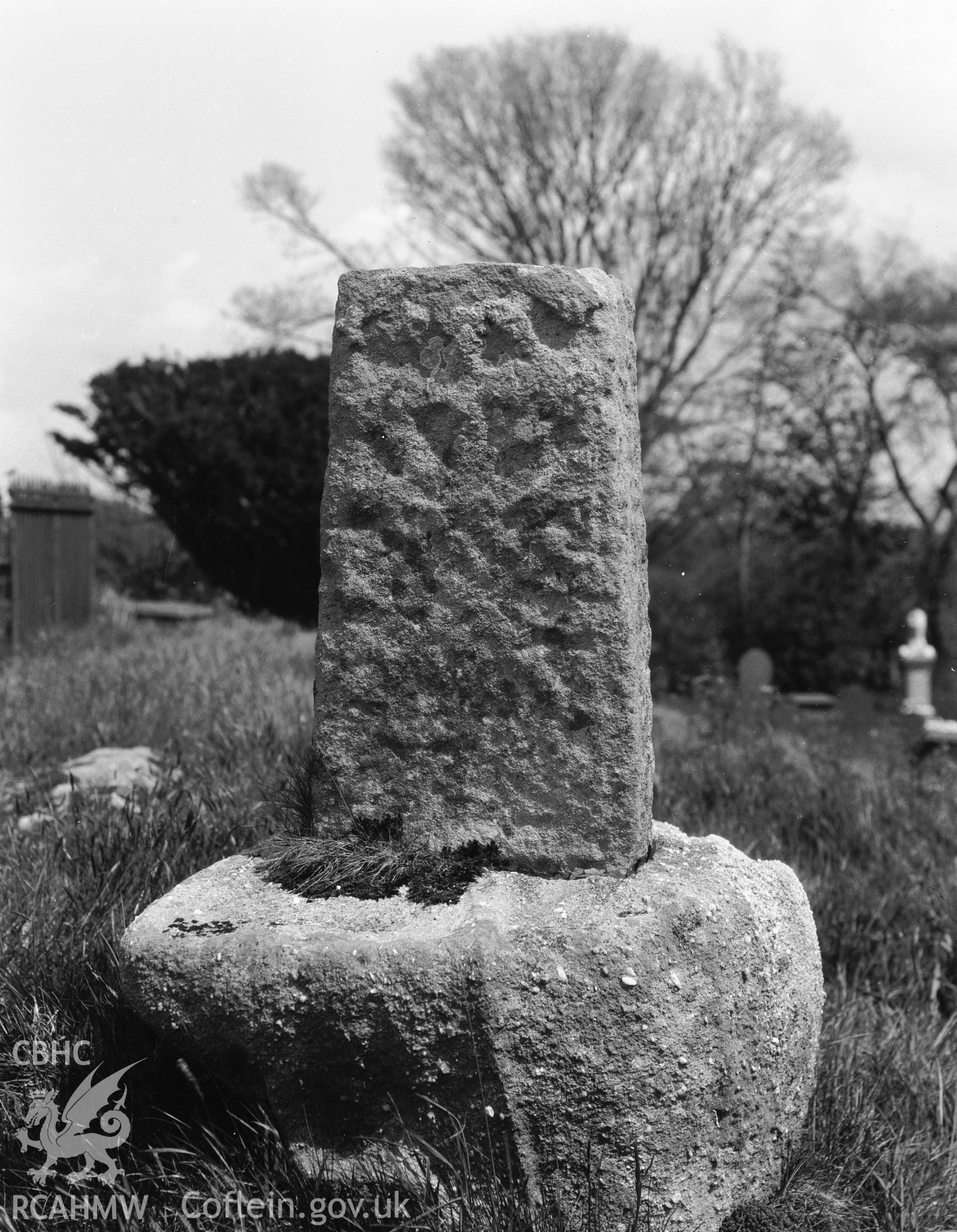 Digitised copy of a black and white negative showing stone in the churchyard produced by RCAHMW March 1929.