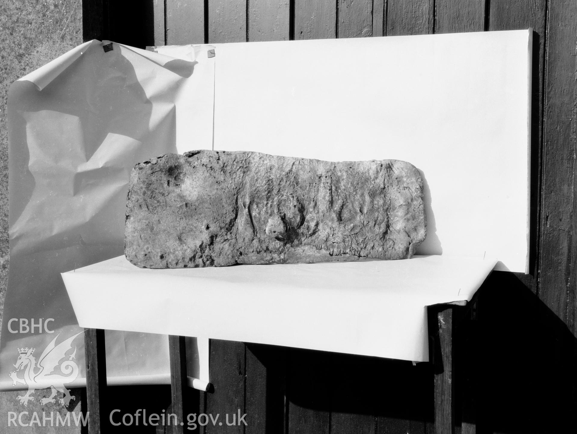 Digitised copy of a black and white negative showing part of lead coffin found at Rhuddgaer, produced by RCAHMW before 1960