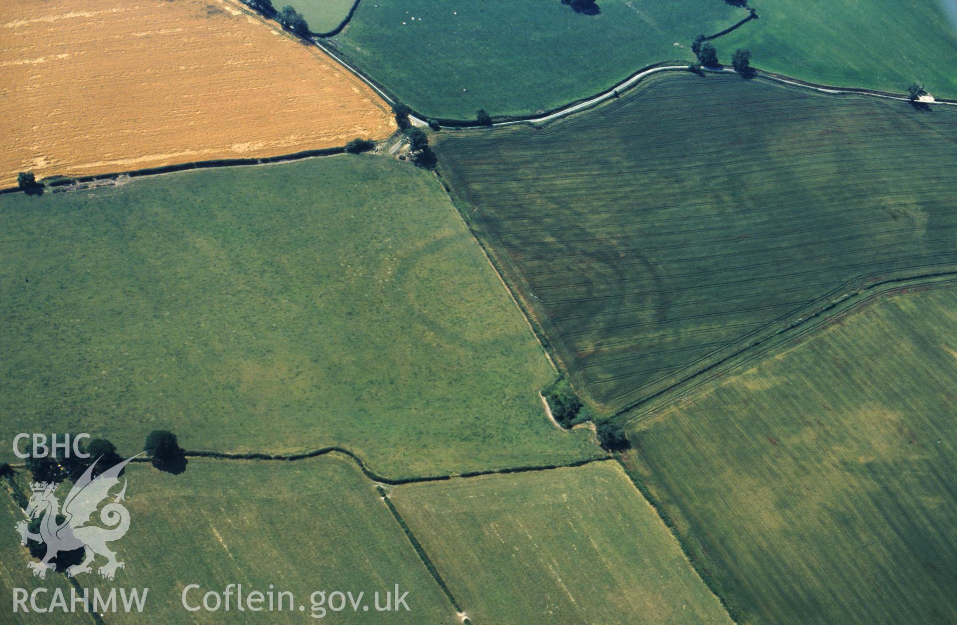 RCAHMW colour slide oblique aerial photograph of enclosure at Collfryn, Llansantffraid, taken by C.R.Musson on the 20/07/1996