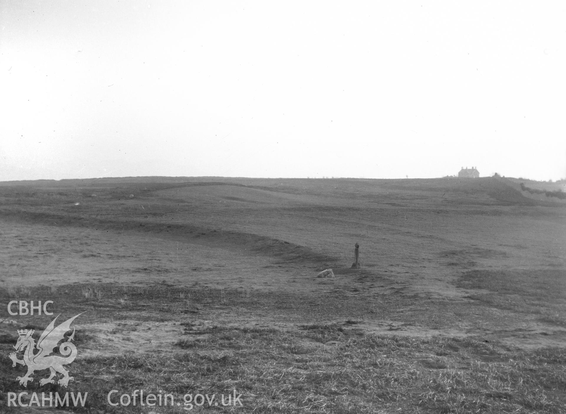 General view of Penmon Park, showing lynchets near the cross in the evening light.