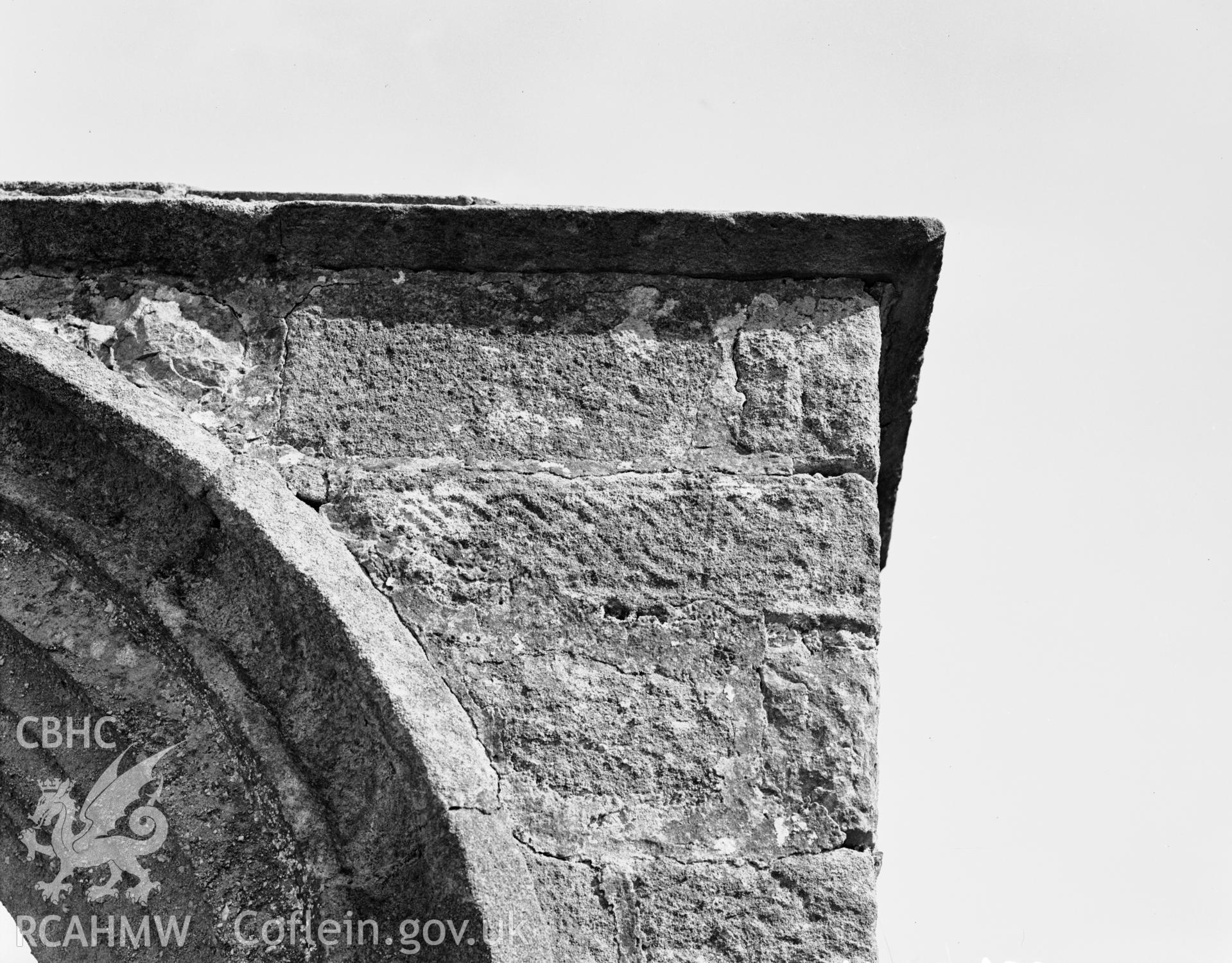 Digitised copy of a black and white negative showing part of the churchyard wall produced by RCAHMW March 1929.