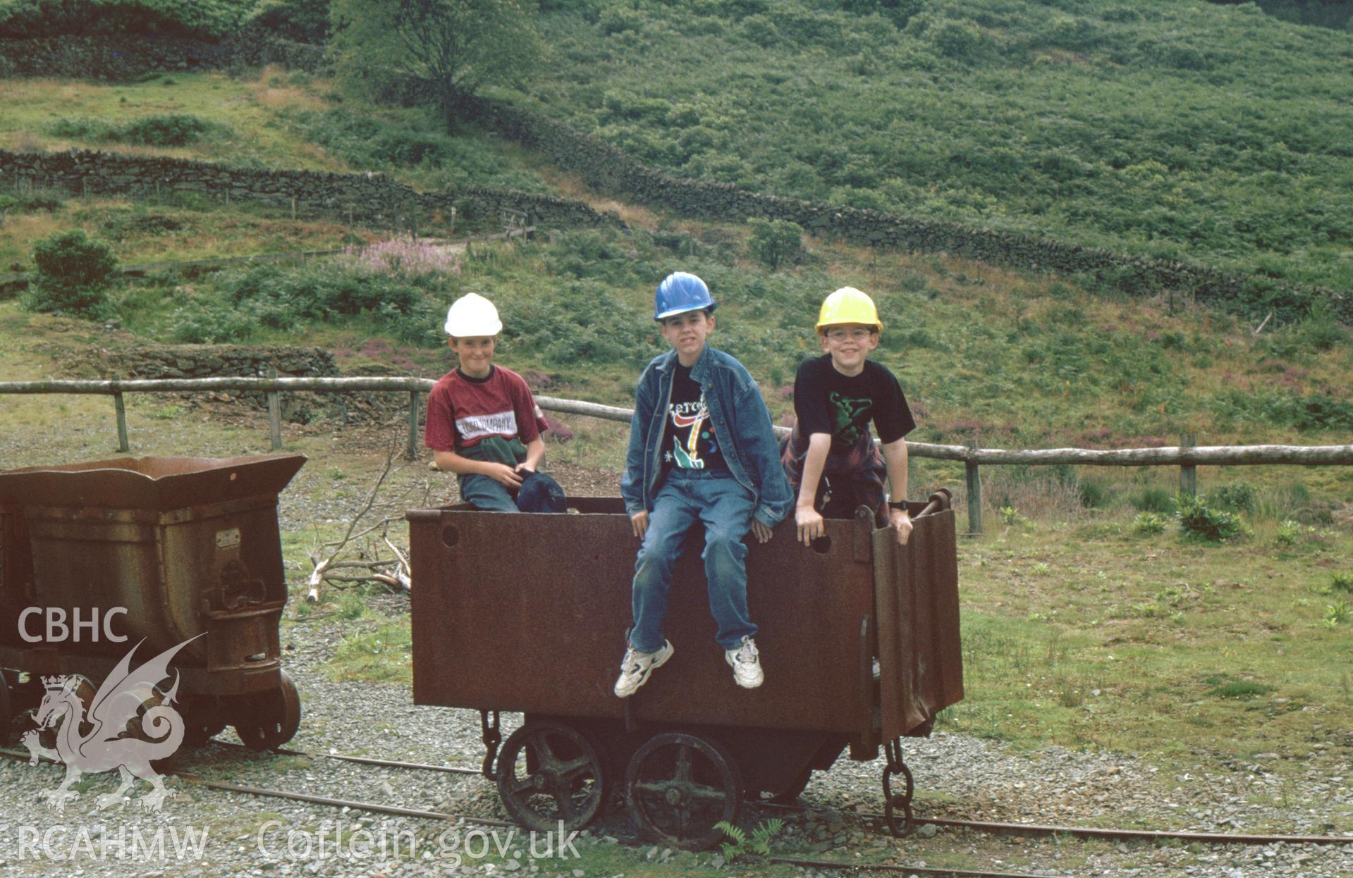 Digitized 35mm slide showing Sygun Copper Mine, mine cars with boys.