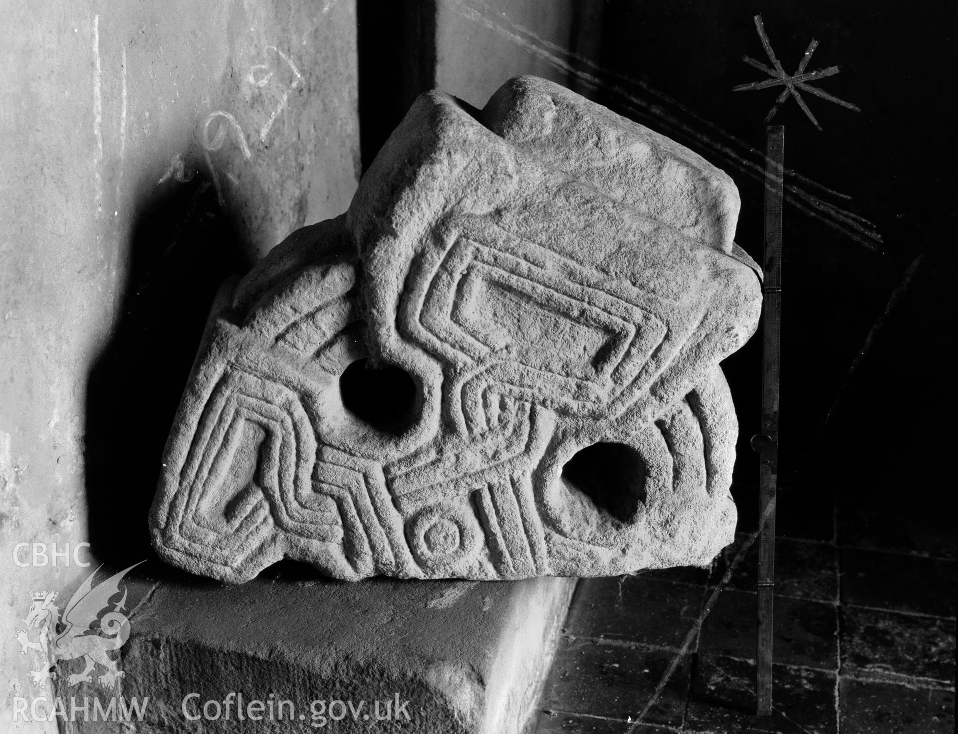 One black and white photograph showing wheel cross head in Llangaffo Church, taken by RCAHMW.