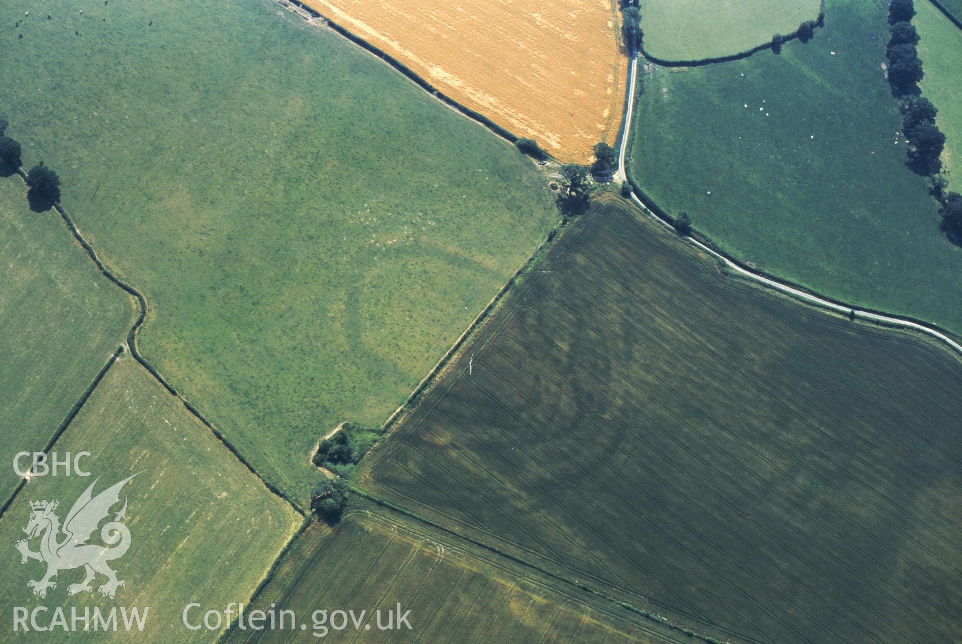 RCAHMW colour slide oblique aerial photograph of enclosure at Collfryn, Llansantffraid, taken by C.R.Musson on the 20/07/1996