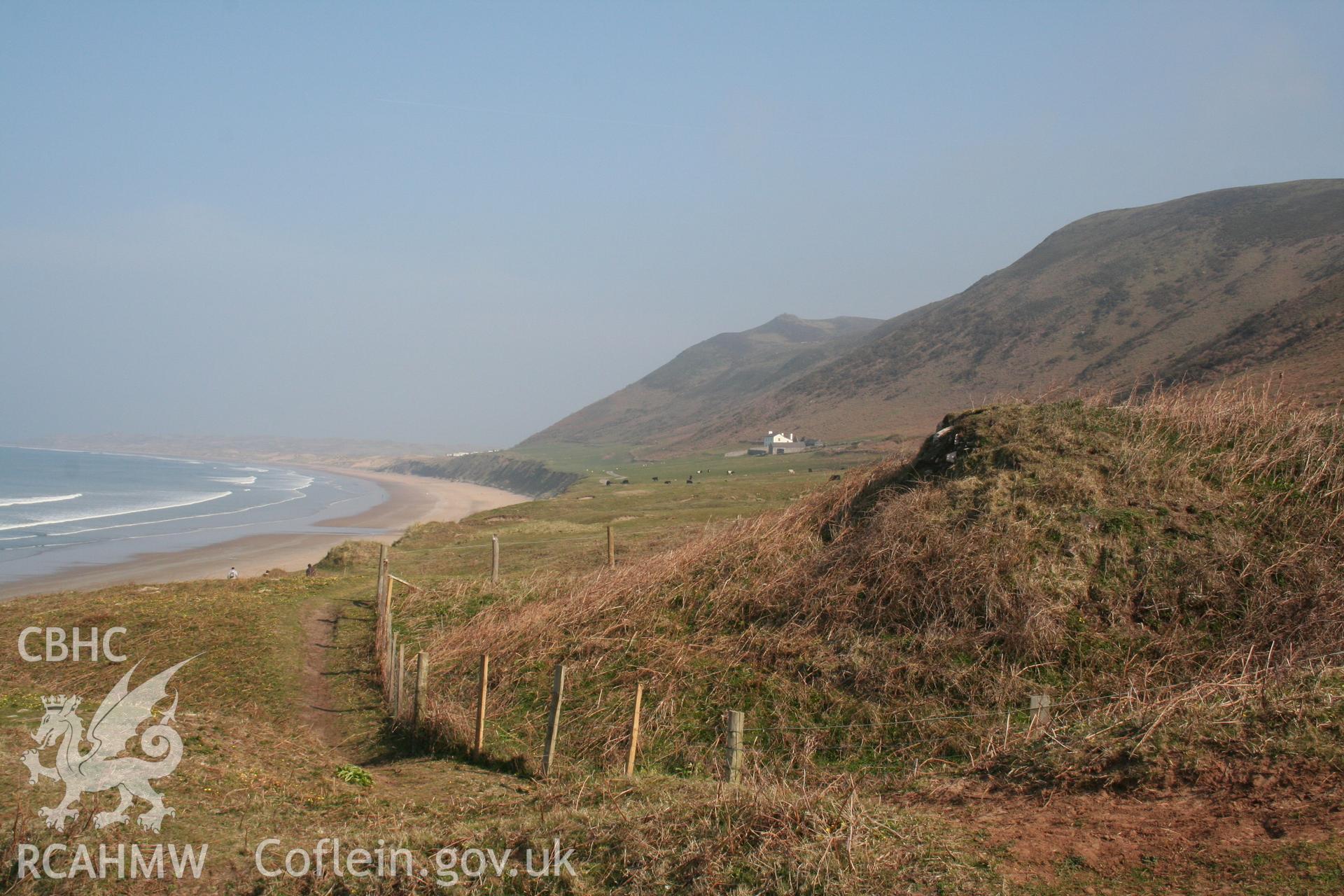 Old Church, Rhossili. Fenced-in remains of Rhossili old church, view to north along Rhossili Beach.