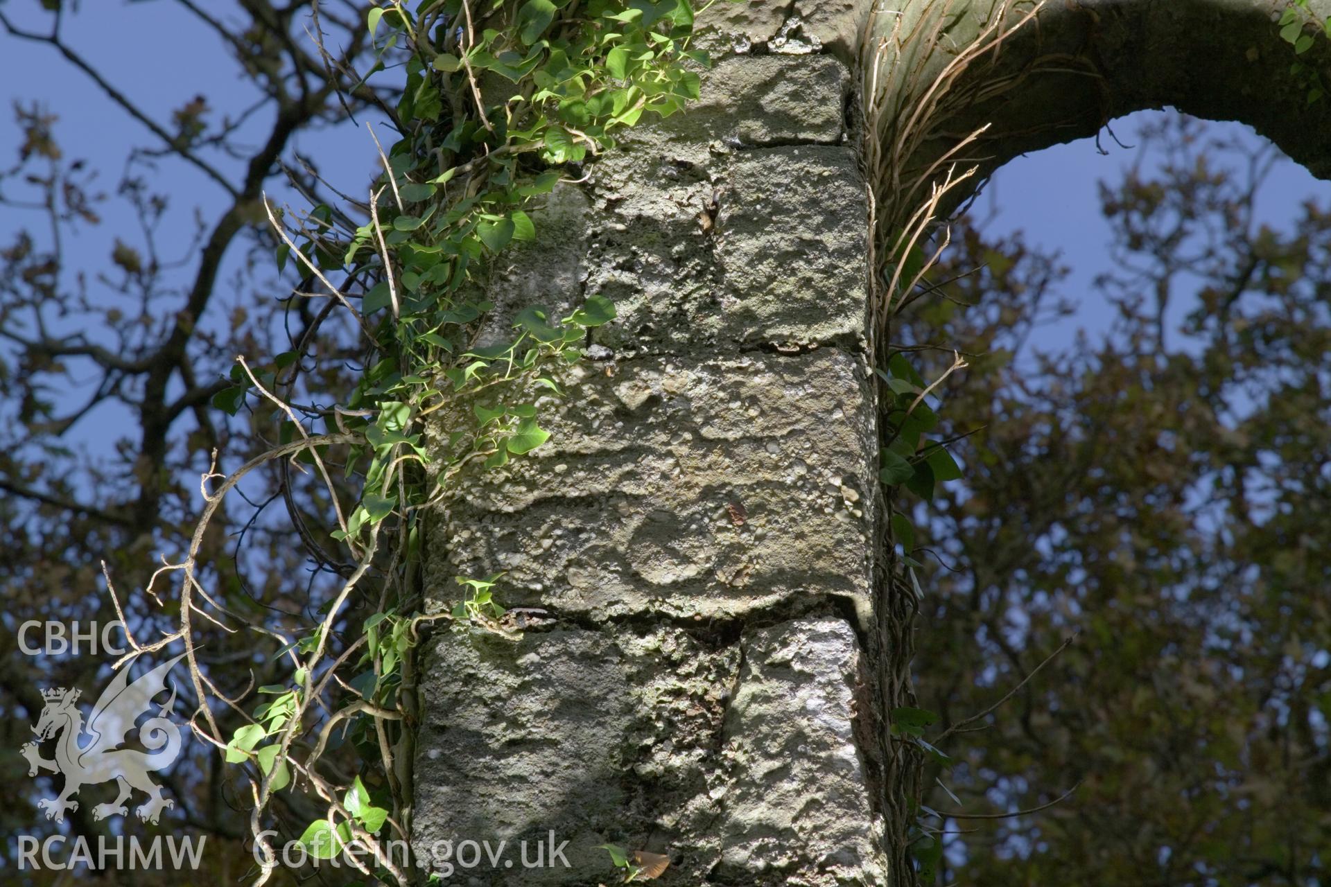 Cross-carved stone lit with artificial light.