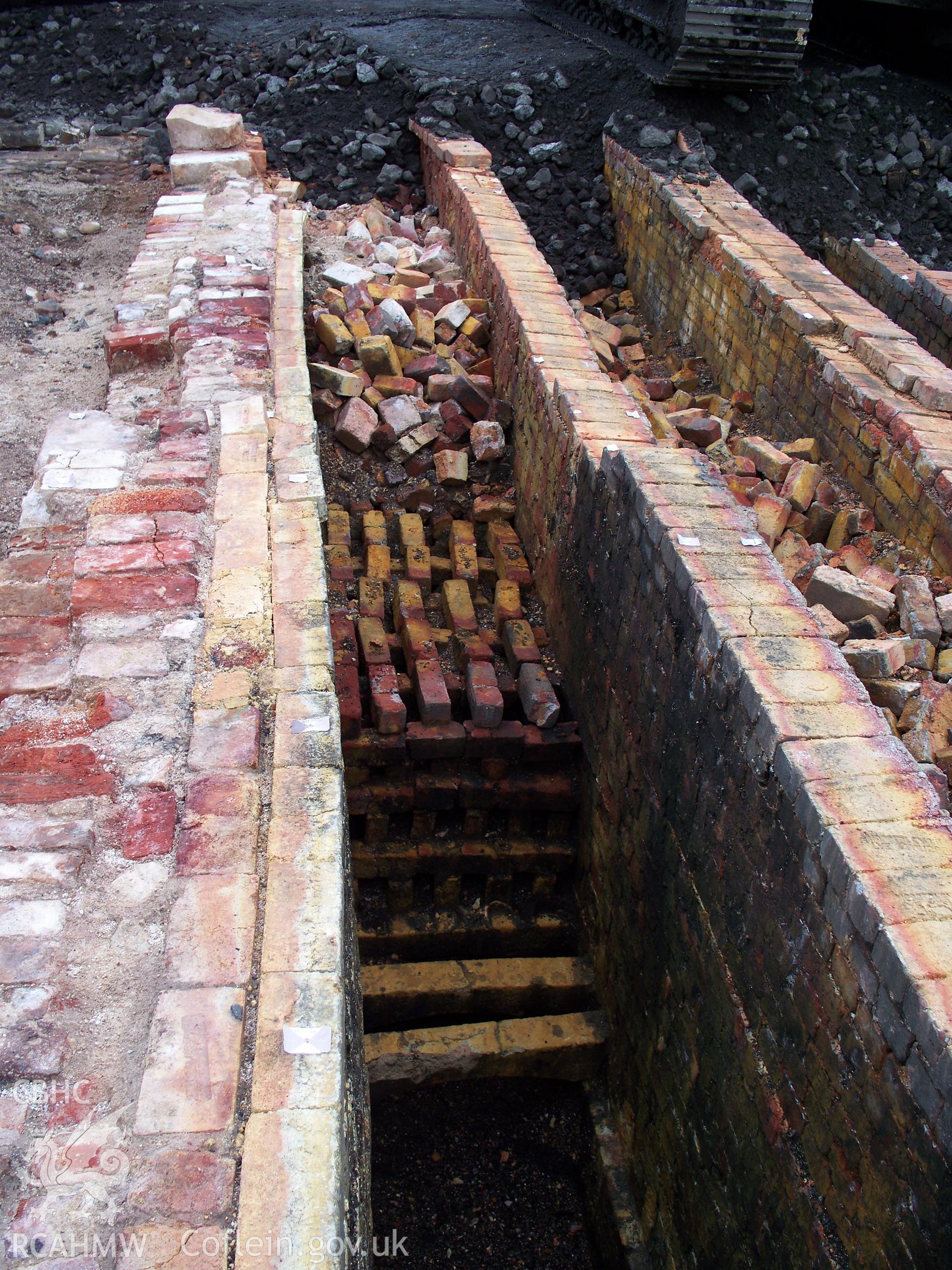 Surviving brick-stacked honeycomb in zinc-furnace flue to be heated by hot gases passing through, late 19th. Century.