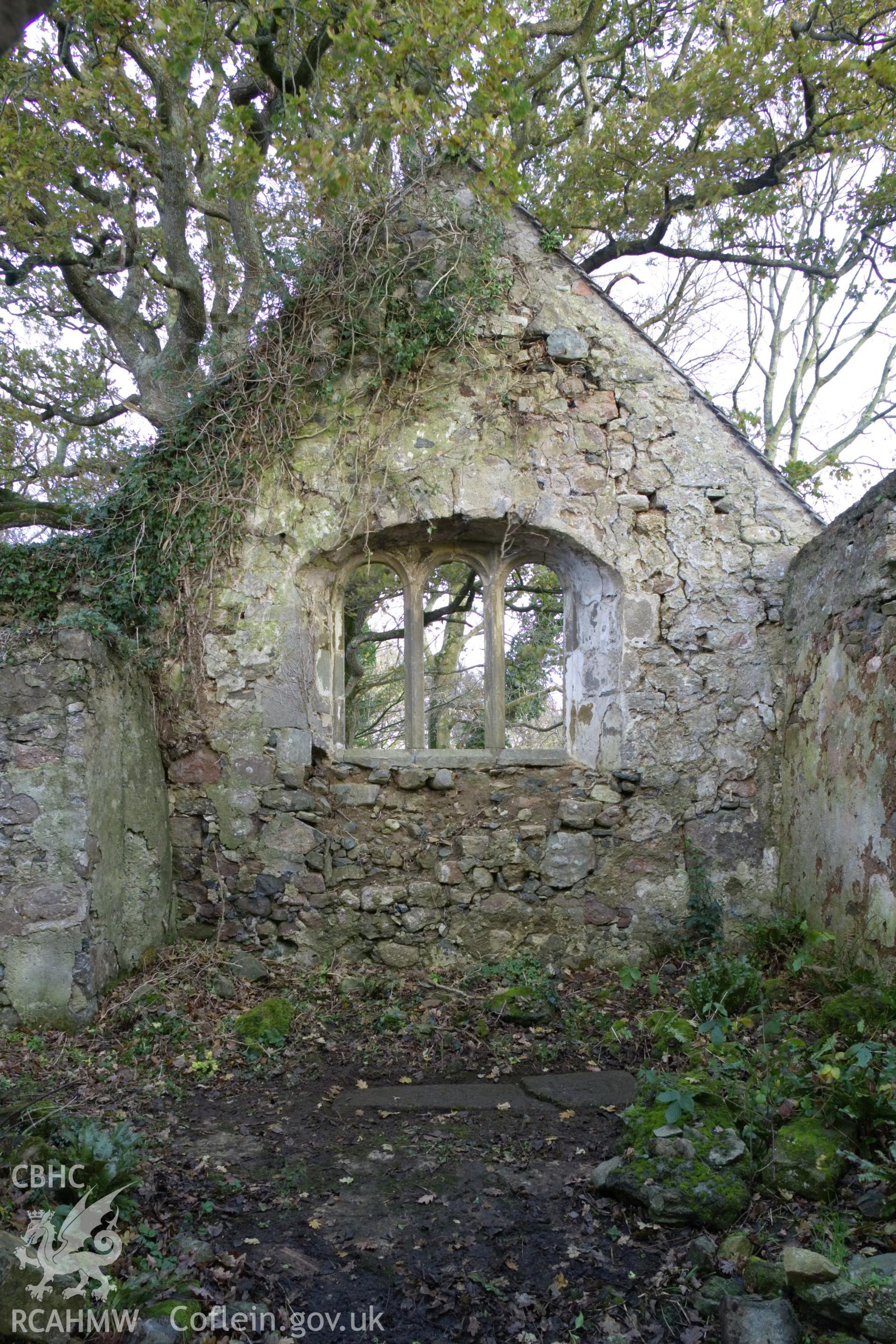 Inside ruined church looking west, crossed-carved stone on floor in centre.