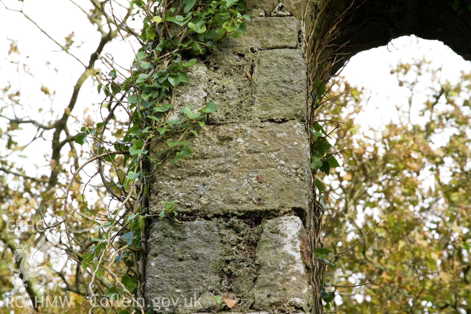 Cross-carved stone set high in belfry.