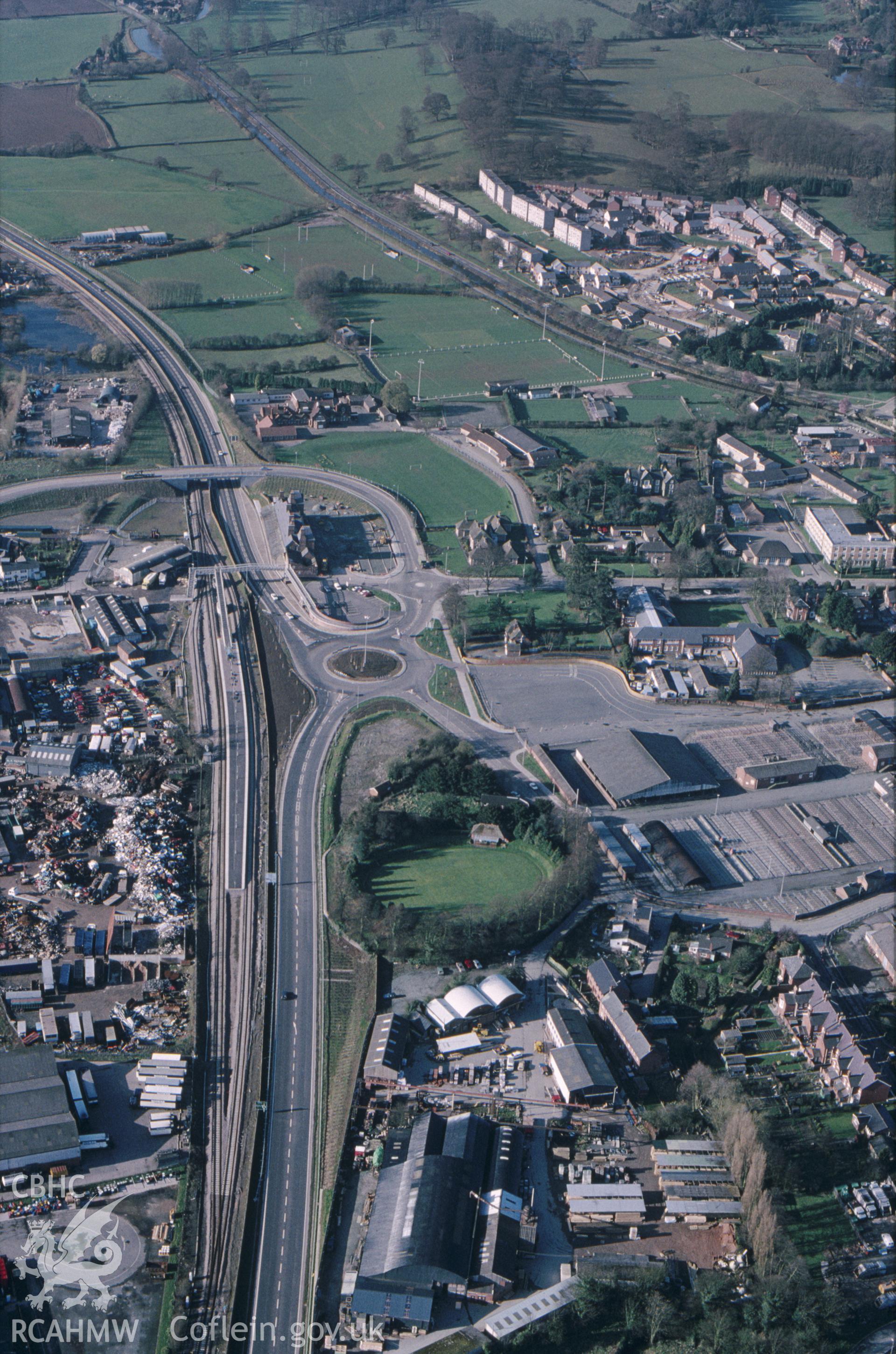 RCAHMW colour slide oblique aerial photograph of Domen Gastell Earthwork Castle, Welshpool, taken by C.R. Musson, 26/03/94