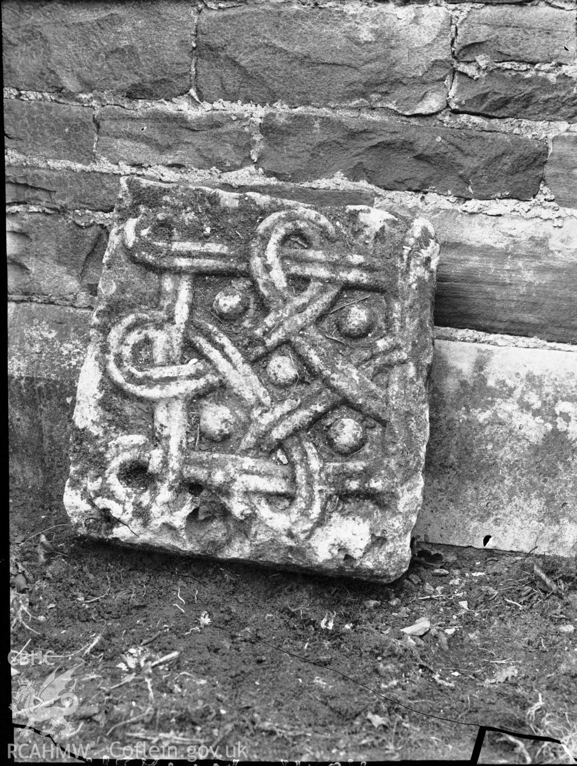 Black and white photo showing decorated stone tile at Merthyr Mawr.