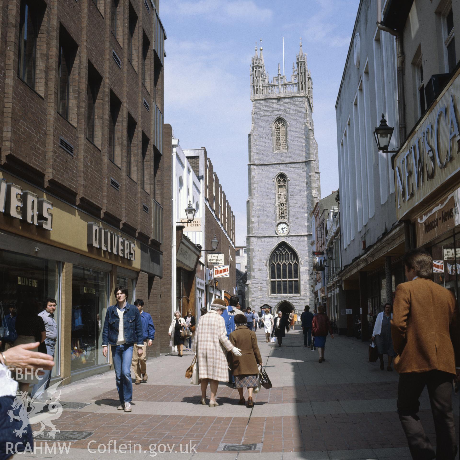 1 colour transparency showing St John the Baptist church, Church Street, central Cardiff with shoppers; collated by the former Central Office of Information.