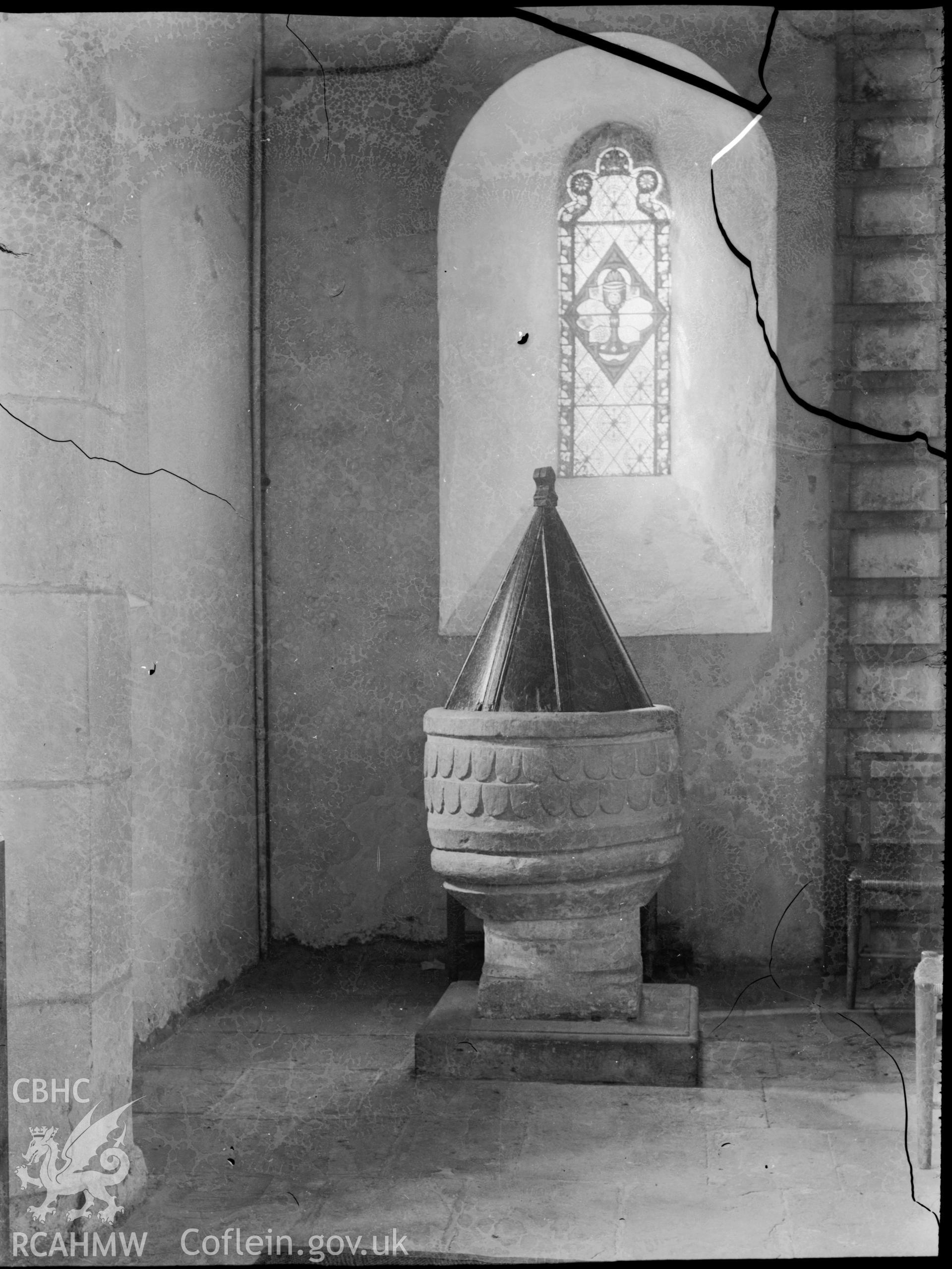 Black and white photo showing the font at St Donat's Church.